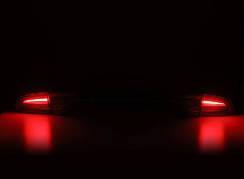 AlphaRex NOVA-Series prismatic LED tail lights for 2015-2023 Dodge Charger with a chrome finish, glowing red.