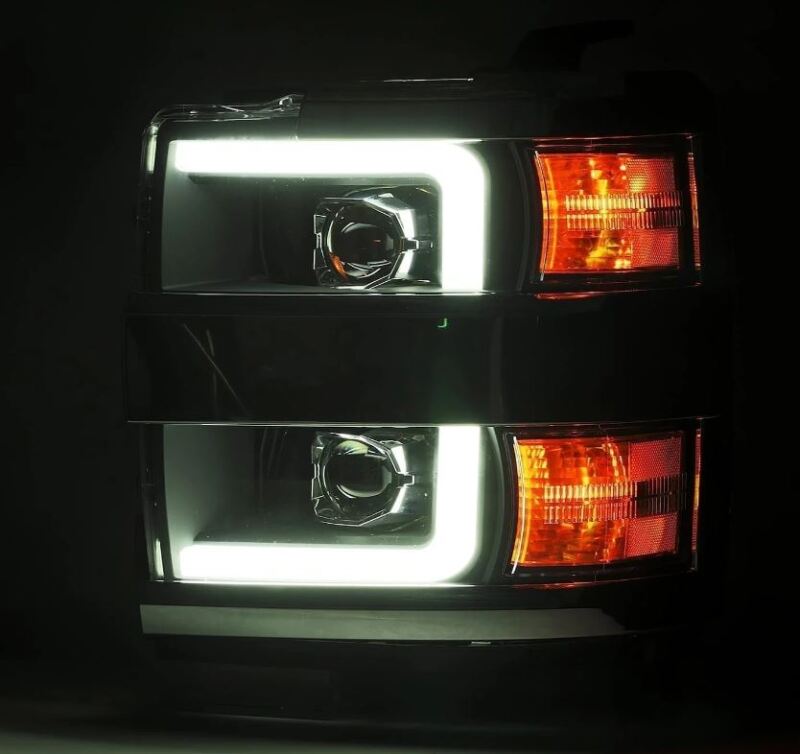 AlphaRex LUXX-Series projector headlights for 15-19 Chevy Silverado 2500/3500, featuring black housing, sequential signals, and daytime running lights.