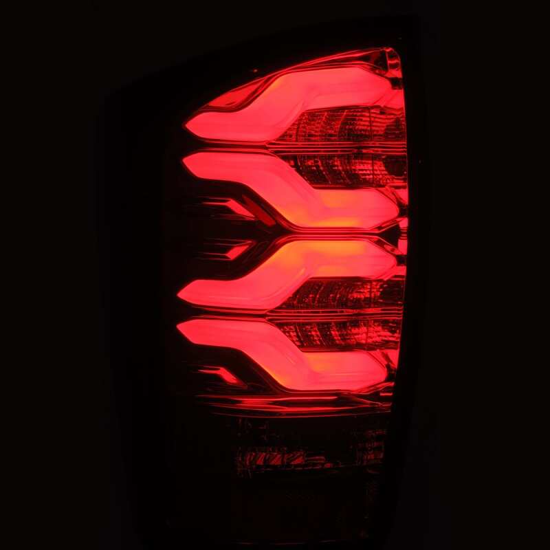 AlphaRex LUXX LED taillights for 16-21 Toyota Tacoma in black and red with sequential signal and active light features.