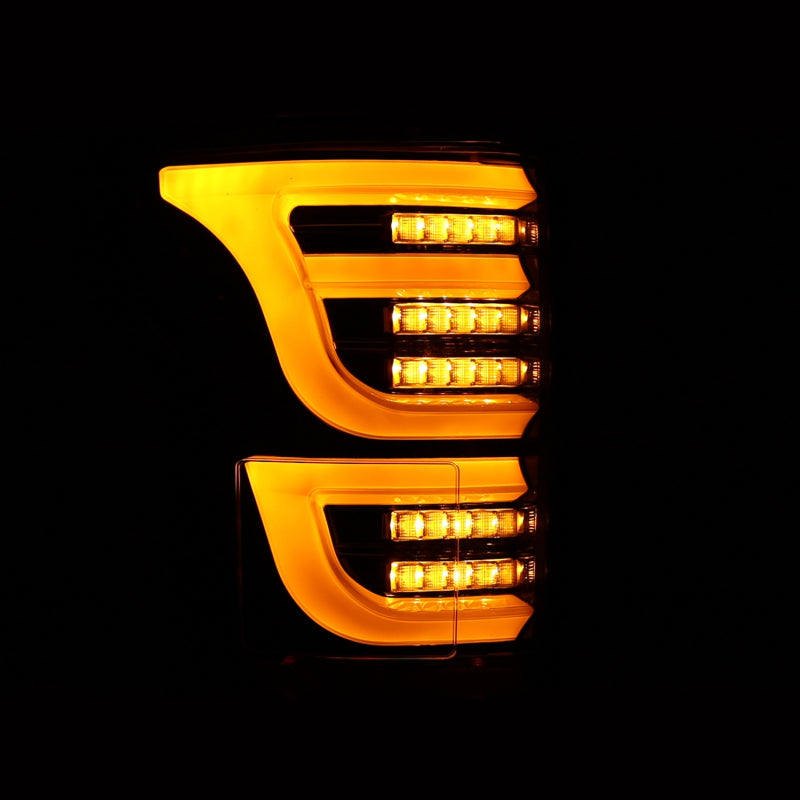 AlphaRex Luxx-Series LED tail lights for 2015-2020 Ford F150 in alpha-black finish, featuring bright amber LED accents.