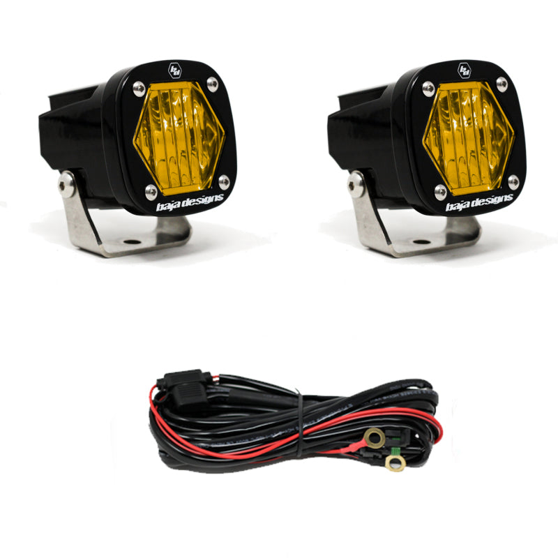 Baja Designs S1 Amber Wide Cornering LED light pair with mounting brackets and wiring harness for offroad vehicles.