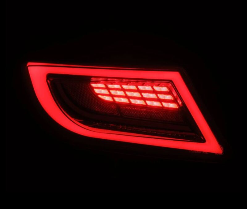 AlphaRex 22-24 Toyota GR86 LUXX LED taillights in black smoke, featuring a sleek design and bright red illumination.