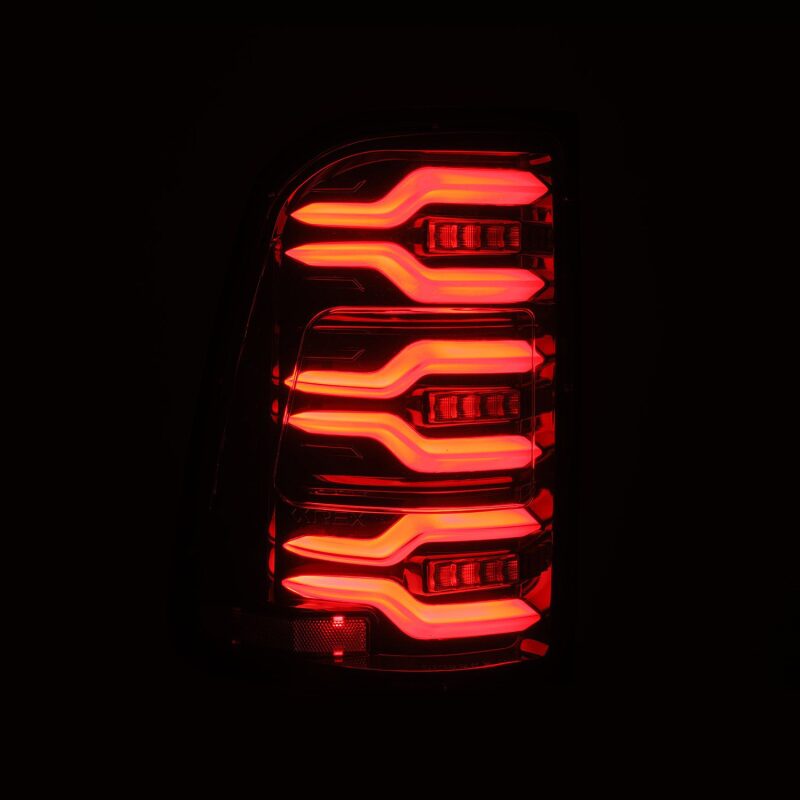 AlphaRex Luxx-Series LED tail lights for 19-21 Dodge Ram 1500 in alpha-black with sequential signals and active lighting.