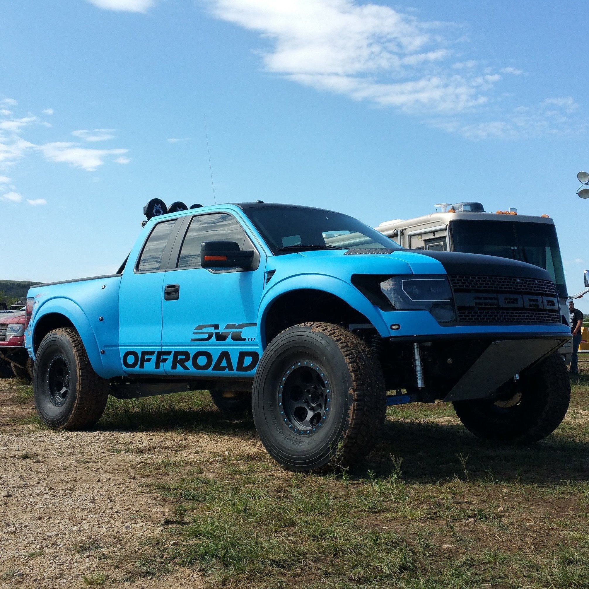 2010-2016 Ford Raptor fenders on a blue offroad truck showcasing rugged design and enhanced performance.