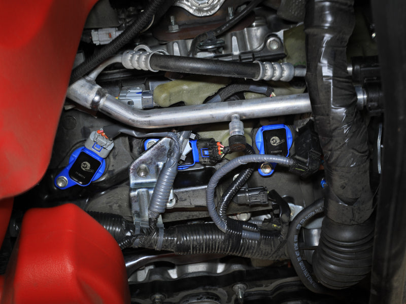 Afe SCORCHER ignition coils installed in a Toyota V6 engine, showcasing performance parts for 2016-2023 trucks and SUVs.
