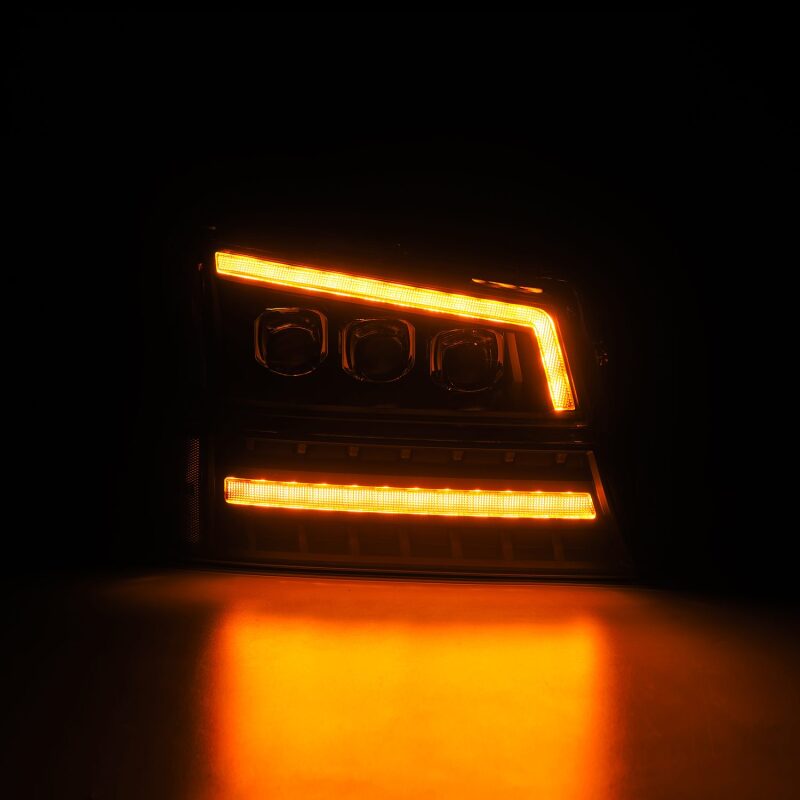 AlphaRex Black NOVA LED projector headlights for 03-06 Chevy Silverado and Avalanche, featuring bright orange LED accents.