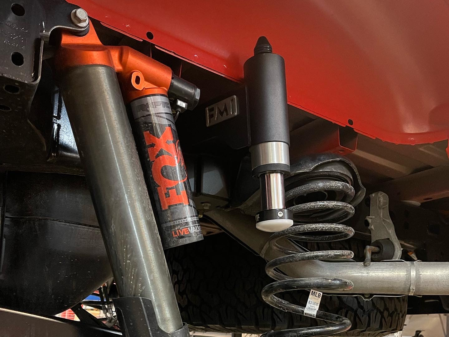 2021-2024 Ford Raptor rear bump stop kit installed, showcasing suspension components and shock absorber details.