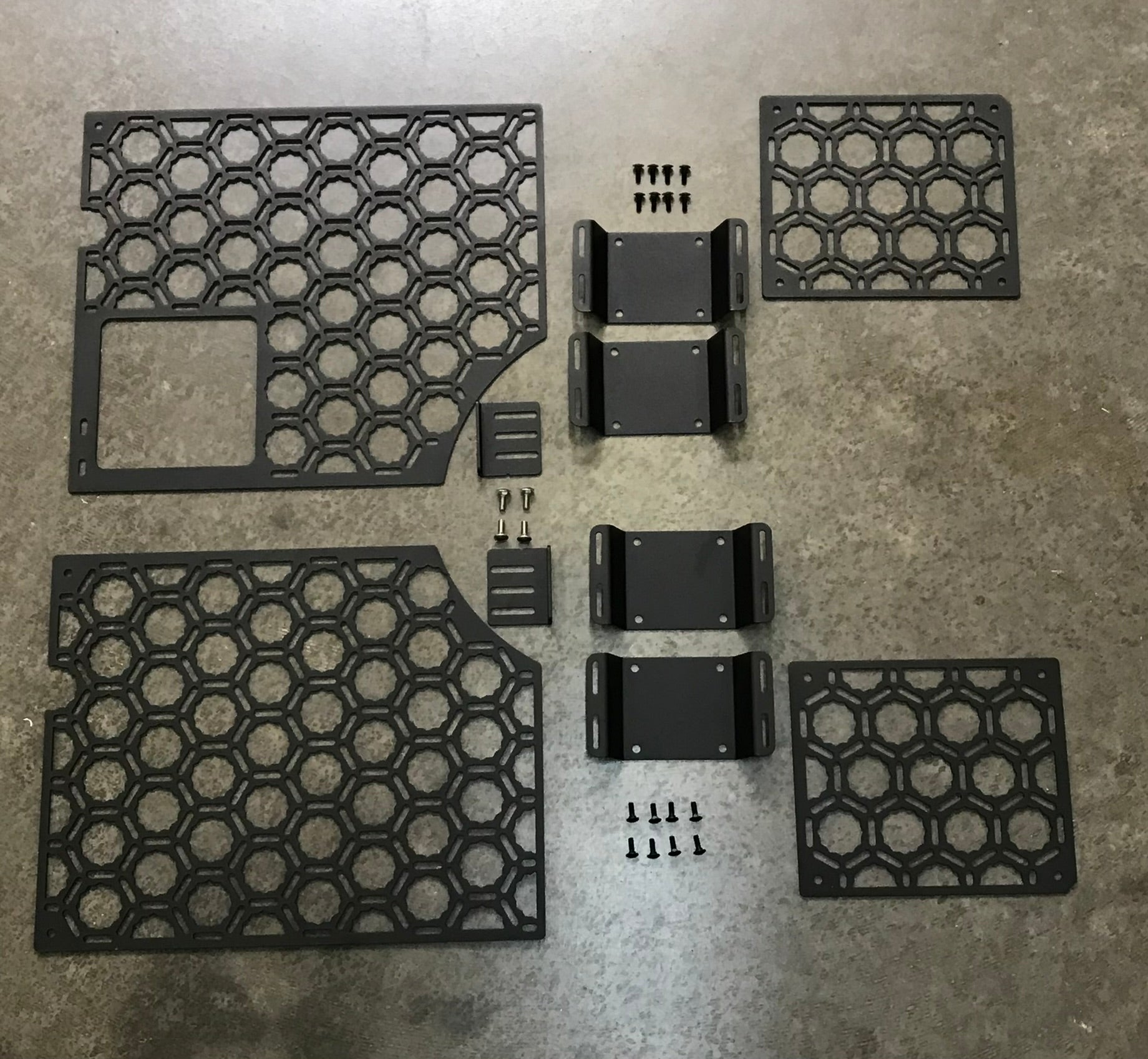 Bedside organizer panel kit for 2021-2023 Ford Raptor and F150, featuring hexagonal design and mounting hardware.