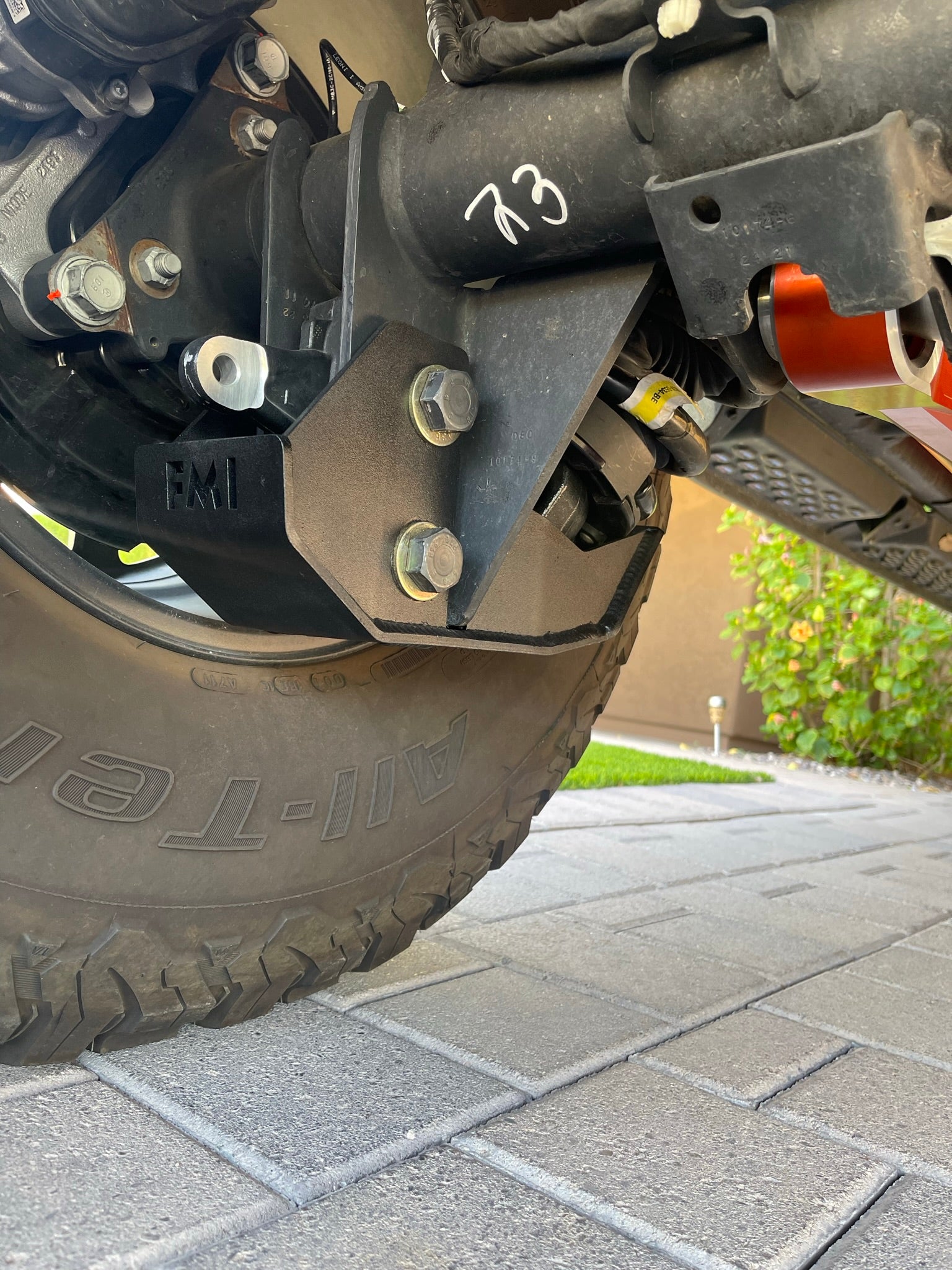 2022 and newer Bronco Raptor rear shock skid kit mounted on a vehicle, showcasing durable metal construction and hardware.