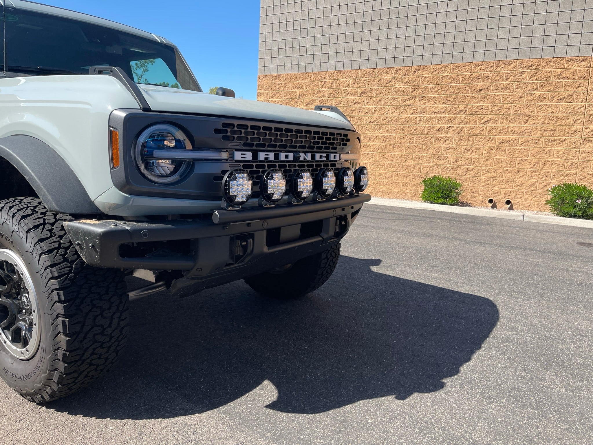 Front view of a 6th Gen Bronco with a light mount kit installed on the modular stock bumper, showcasing multiple lights.