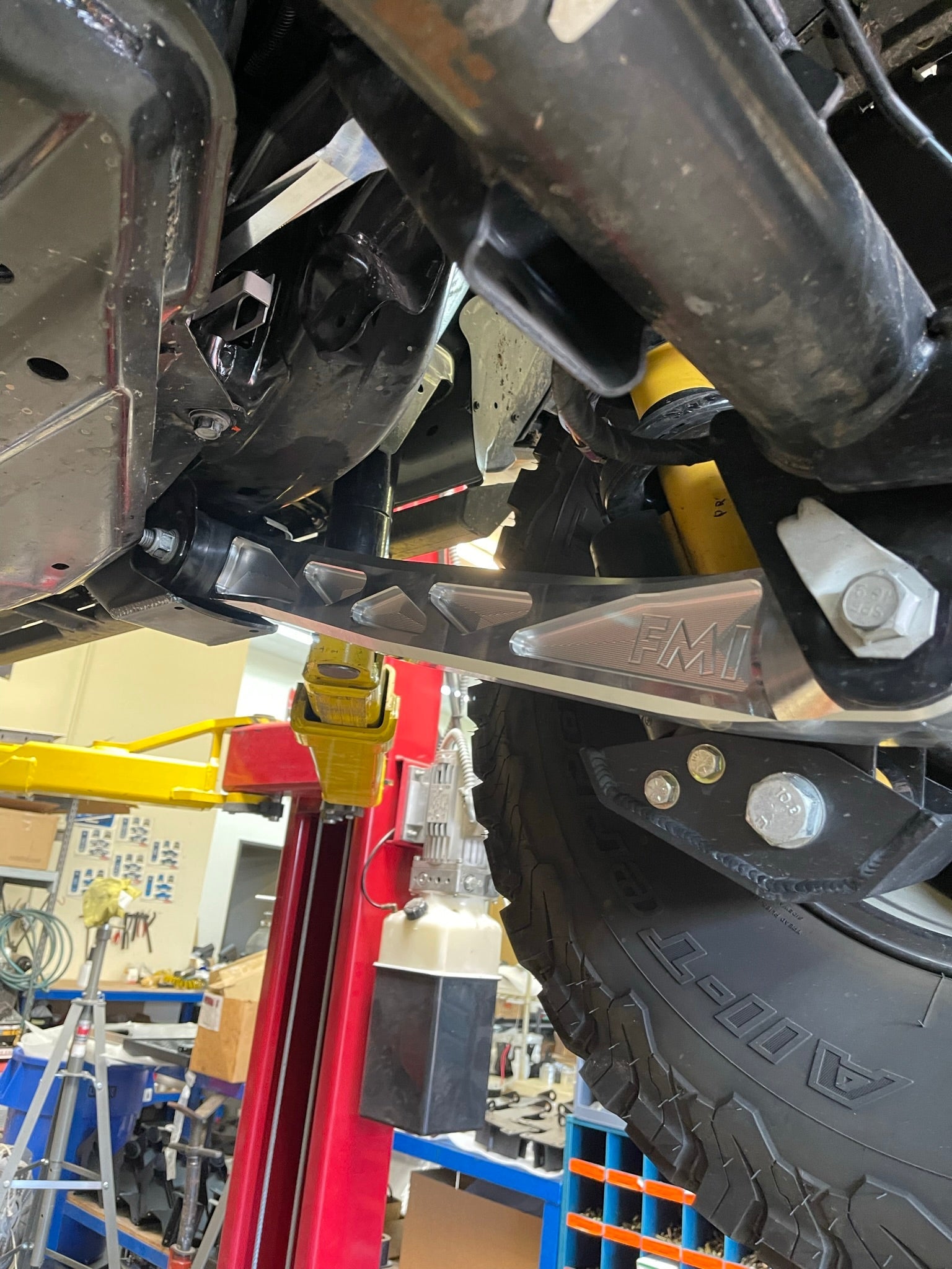 Bronco rear suspension kit featuring billet aluminum rear arms installed under a vehicle, showcasing durability and performance.