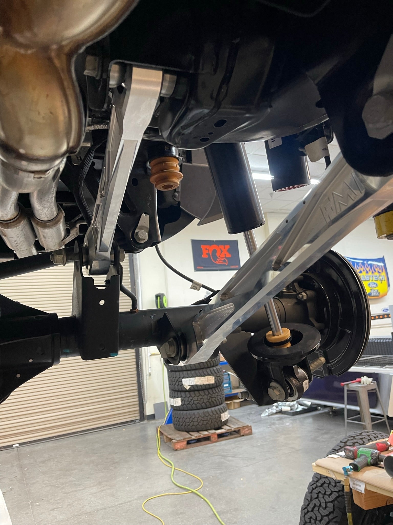 Bronco Raptor billet aluminum rear suspension lower arms installed, showcasing durability and performance enhancements for offroad vehicles.