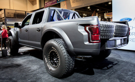 2017 Up Raptor Long Travel Front Suspension Kit displayed on a modified truck with enhanced offroad capabilities.