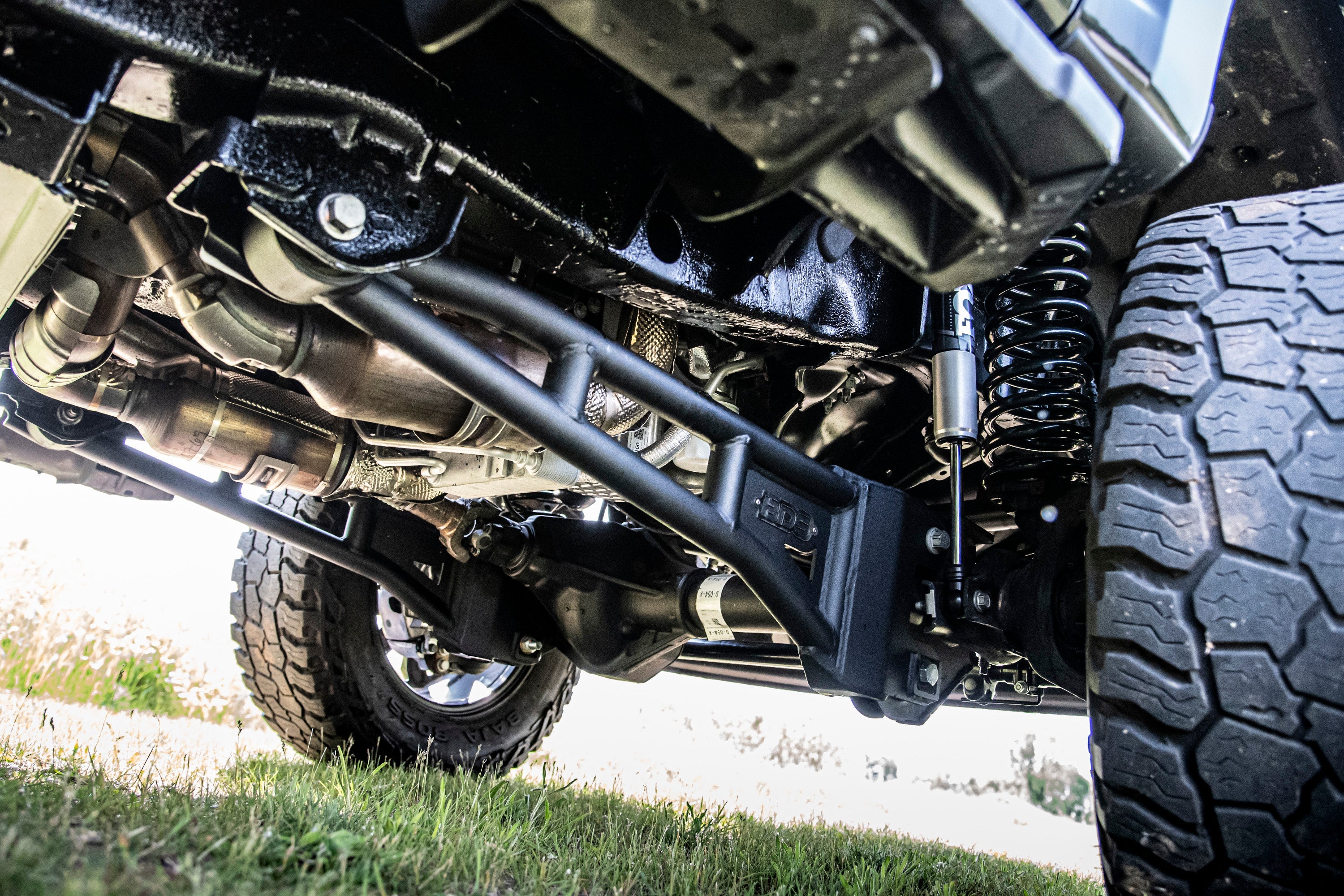 3 inch lift kit with radius arm installed on a Ford F250/F350 Super Duty 4WD, showcasing suspension components and undercarriage.