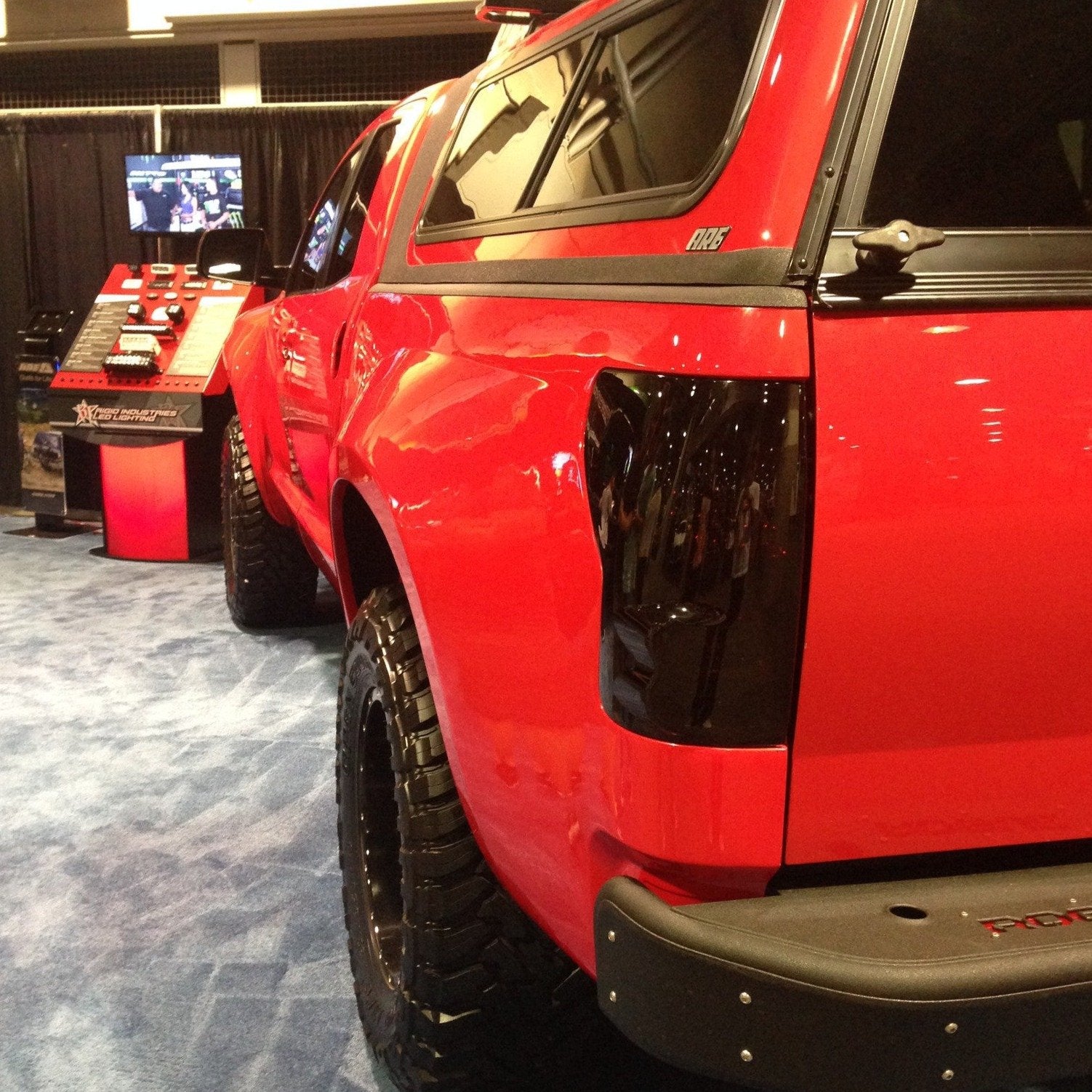 2007-2013 Toyota Tundra bedsides showcased on a modified truck with a glossy red finish and off-road tires.