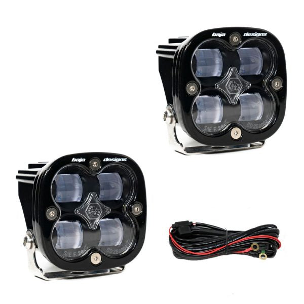 Baja Designs Squadron SAE off-road lights with a black housing, featuring four LED lenses and wiring harness.