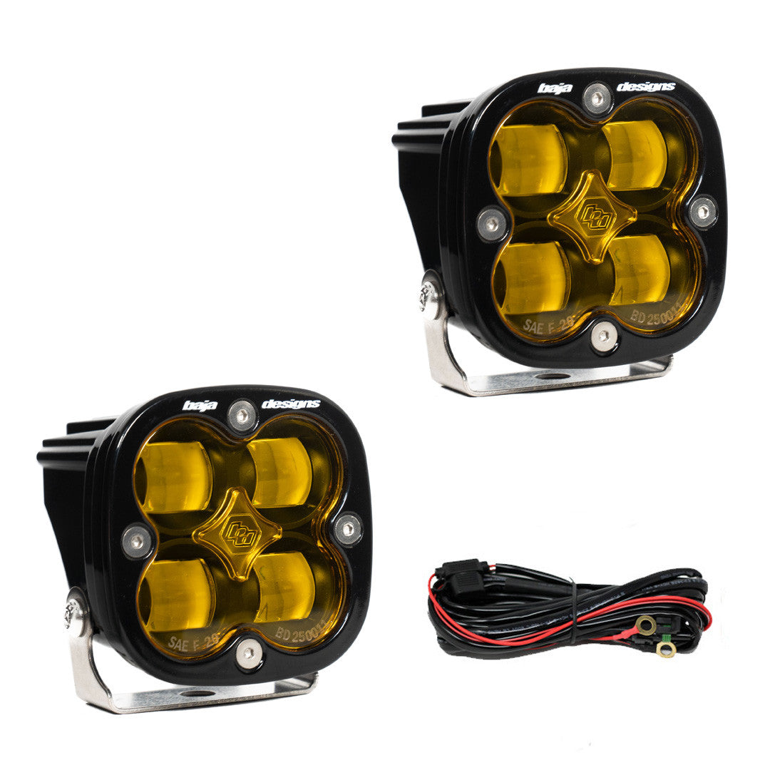 Baja Designs Squadron SAE off-road lights with yellow lenses and mounting brackets, designed for enhanced visibility.