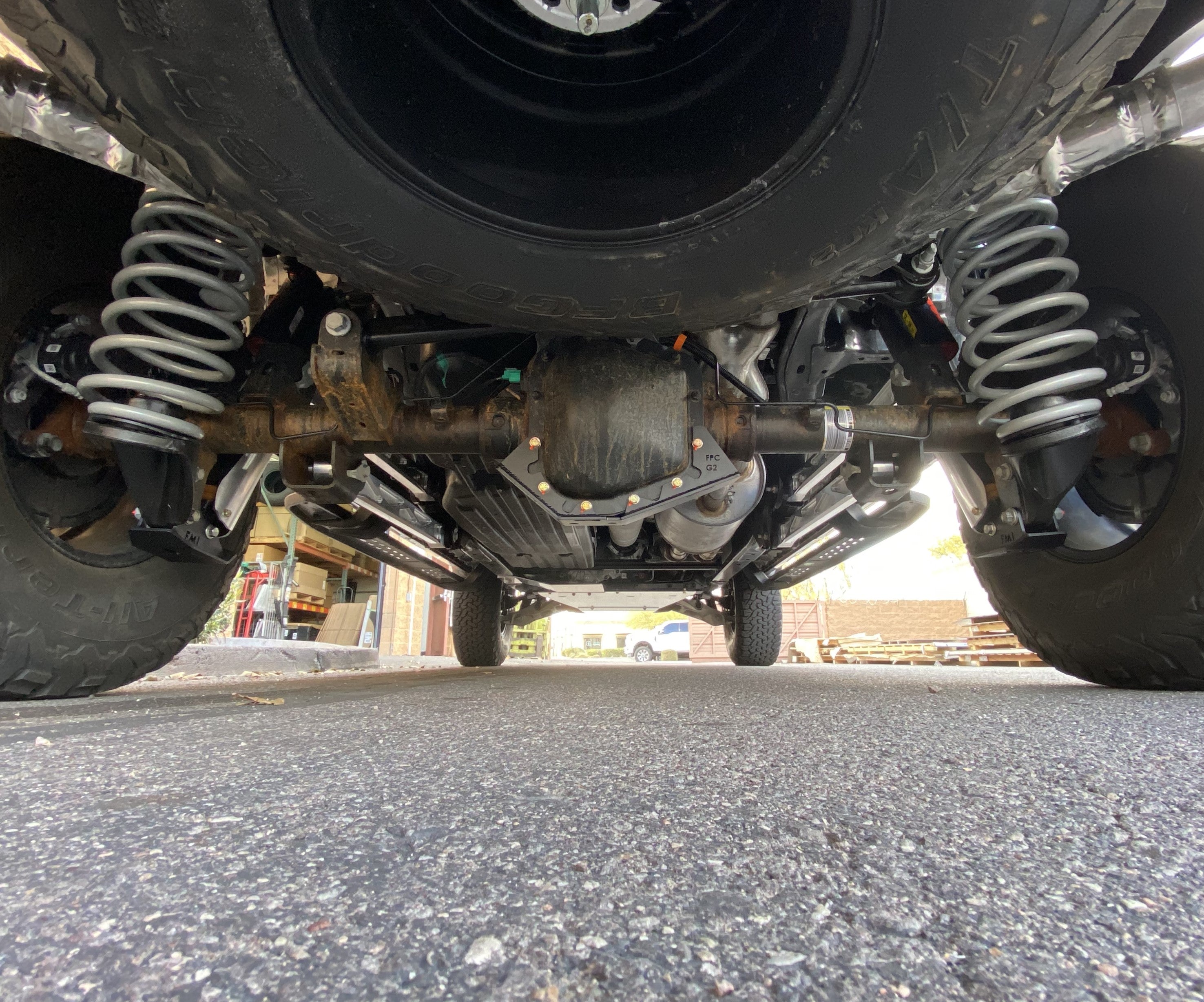 Rear view of a 2017-2024 Raptor showcasing the differential skid plate kit, highlighting off-road suspension and durability.