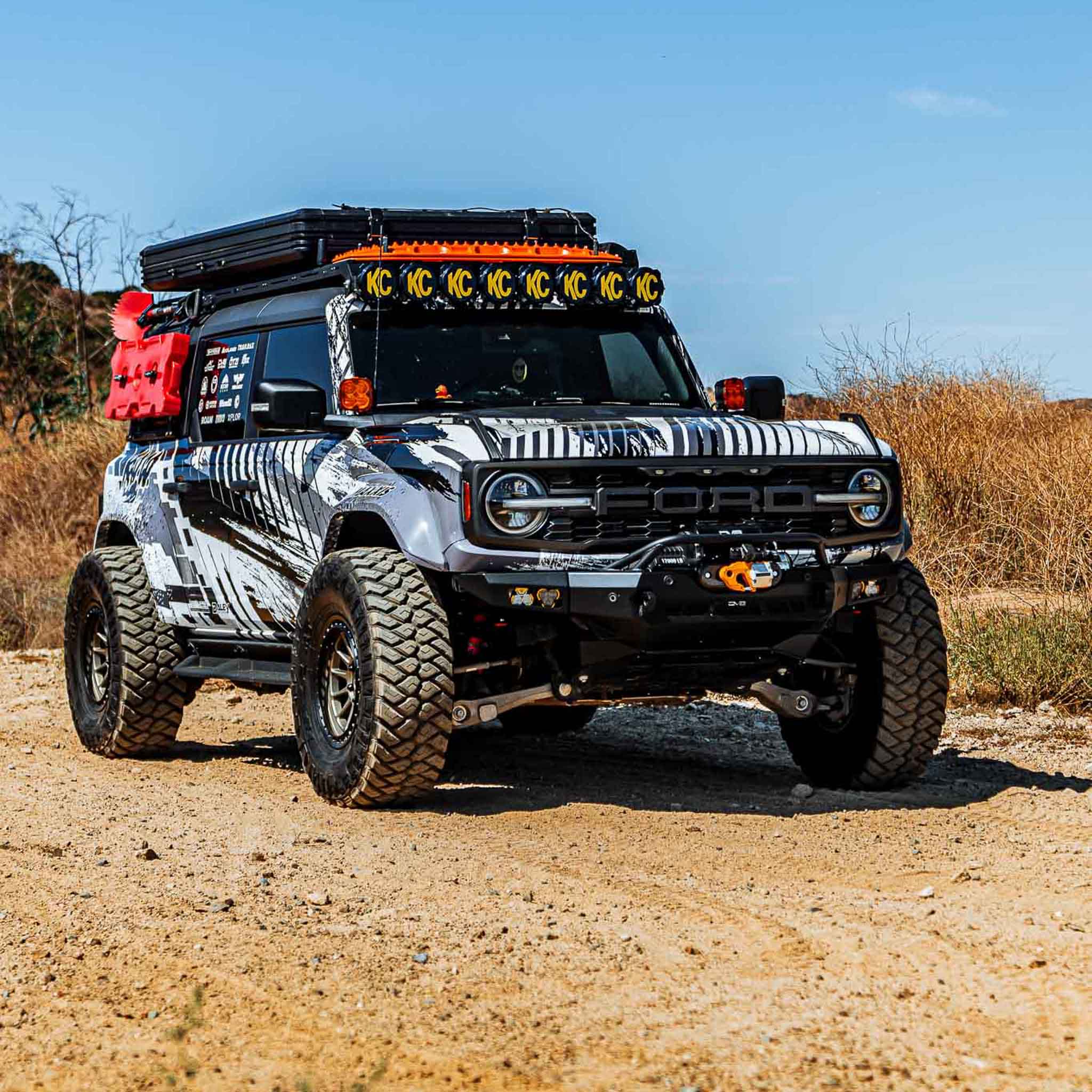 2022-2025 Ford Bronco Raptor with a rear quarter kit, showcasing rugged off-road capabilities in a desert setting.