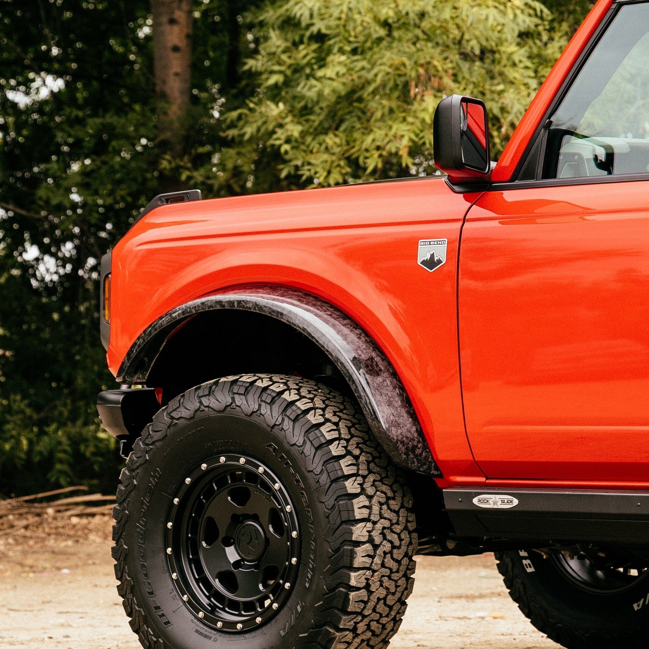 2021-2025 Ford Bronco Sasquatch Flares on an orange Bronco, enhancing off-road capability and style.