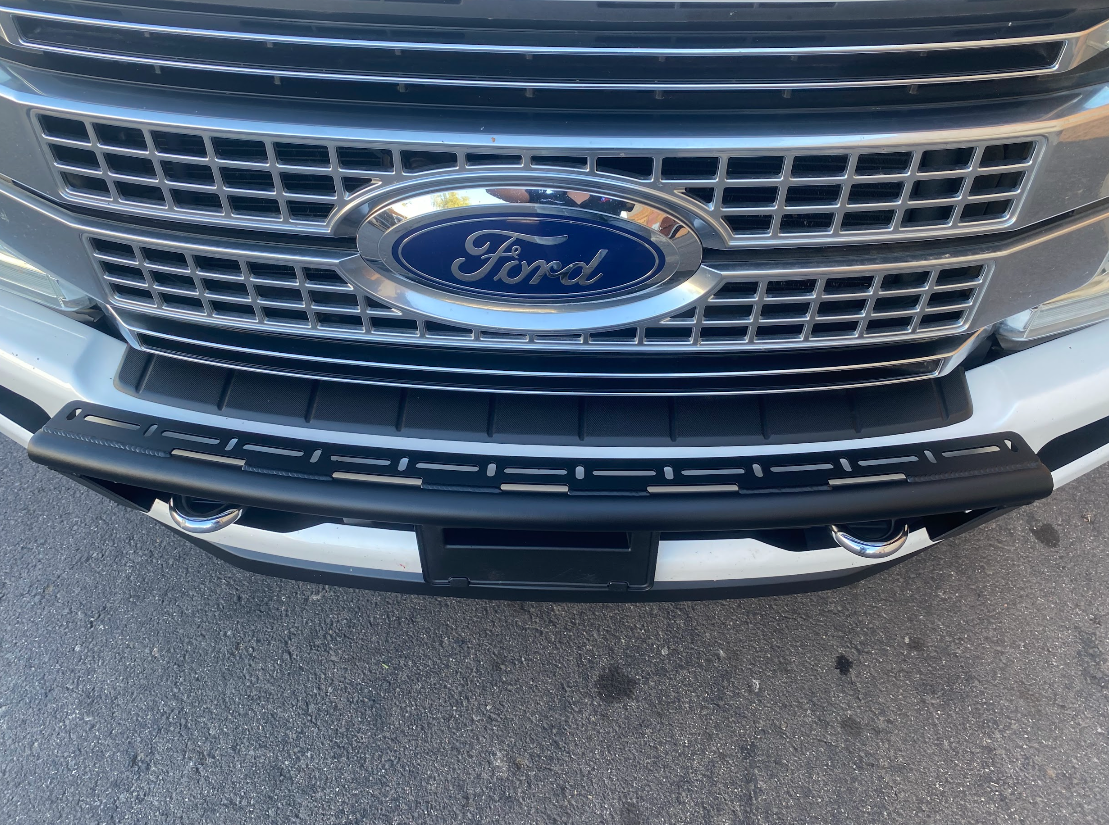 Front view of a 2017-2022 Ford F-250 Super Duty with a light mount kit installed on the stock bumper.