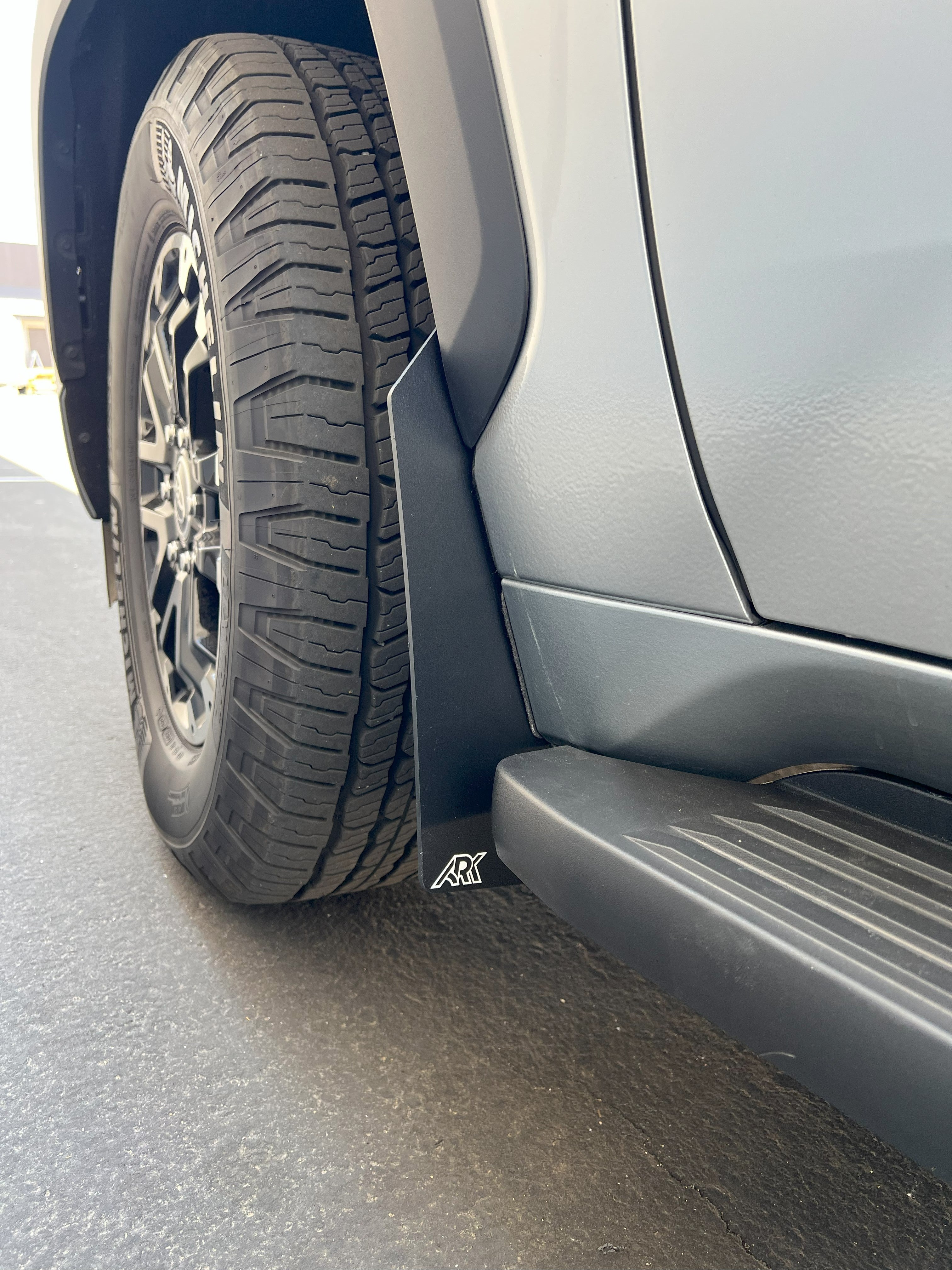 2022+ Toyota Sequoia TriXPoly Mid Mud Flaps installed on a vehicle, showcasing tire and side profile for offroad protection.