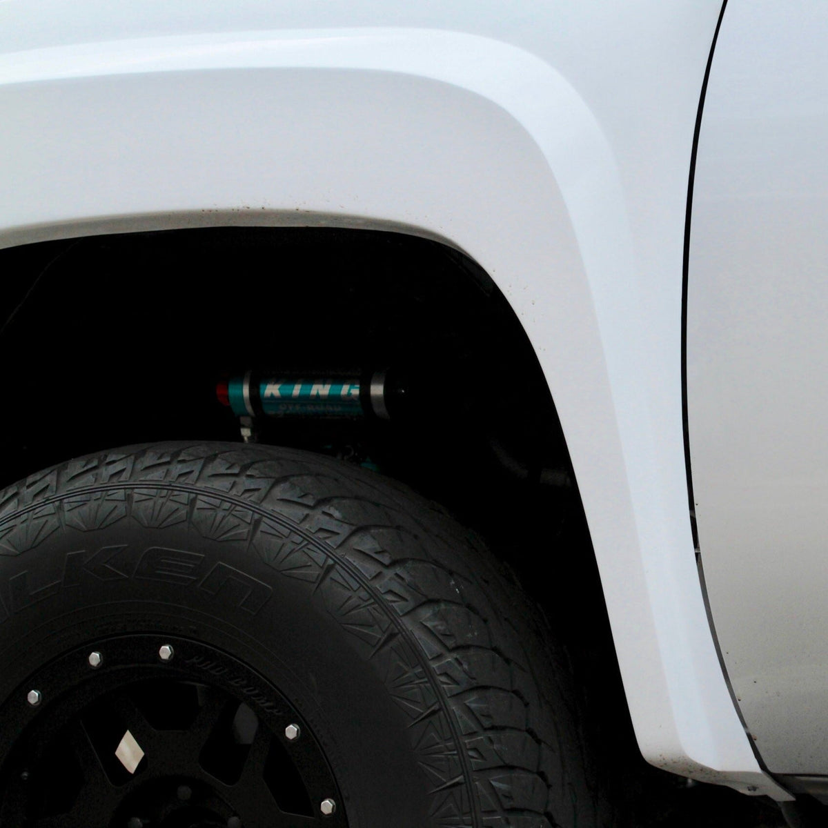 2007-2013 Chevrolet Silverado fender showcasing a close-up view of the tire and suspension components.