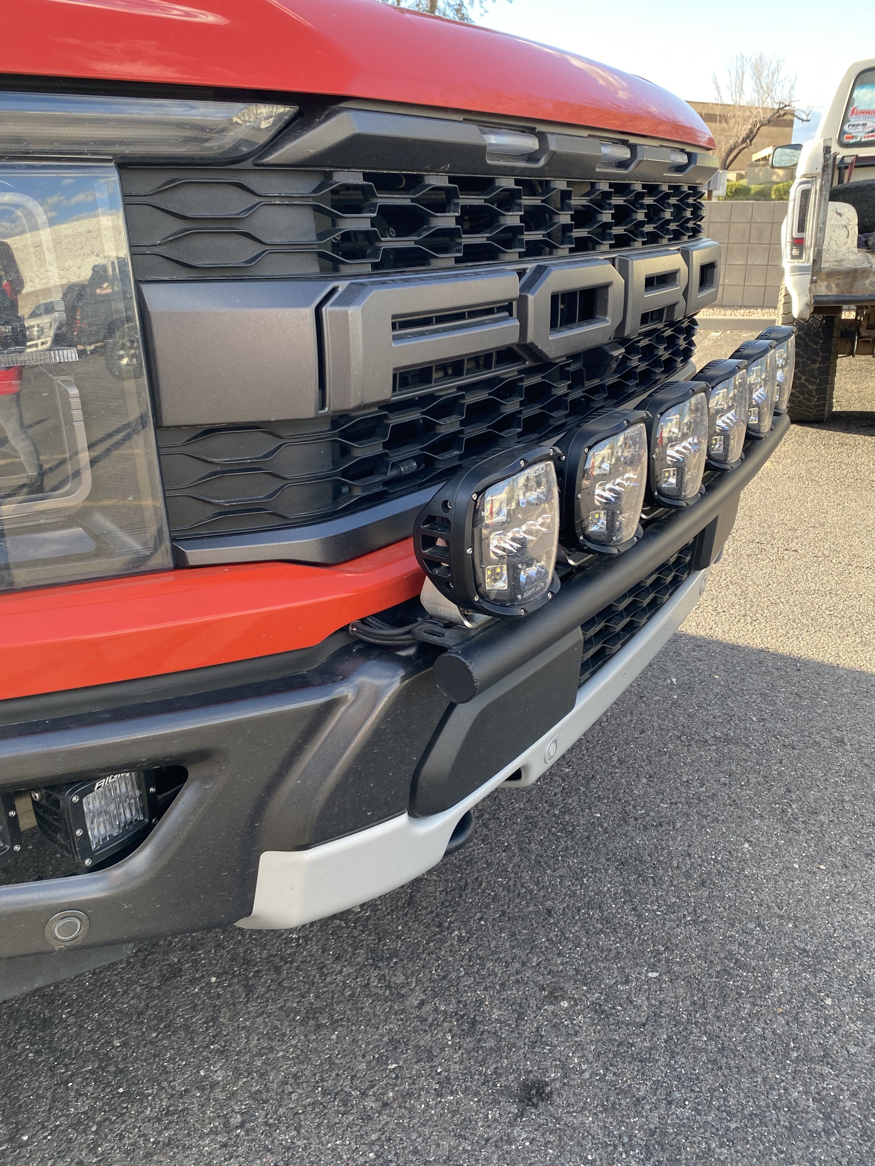 2024 Raptor Front Light Mount Kit on a modular bumper, showcasing multiple light options for enhanced visibility.