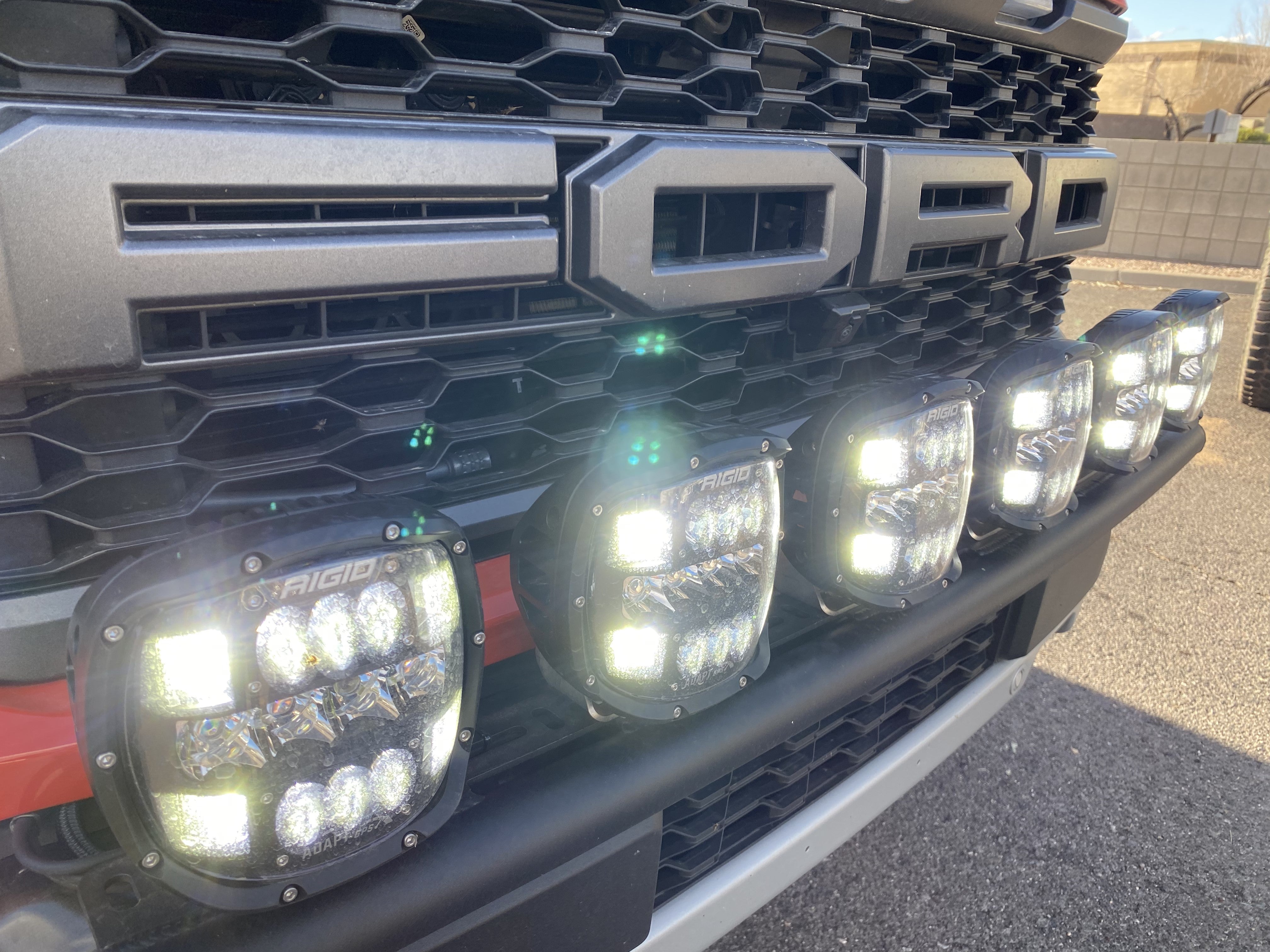 2024 Raptor Front Light Mount Kit showcasing multiple lights on a modular bumper for enhanced visibility and customization.