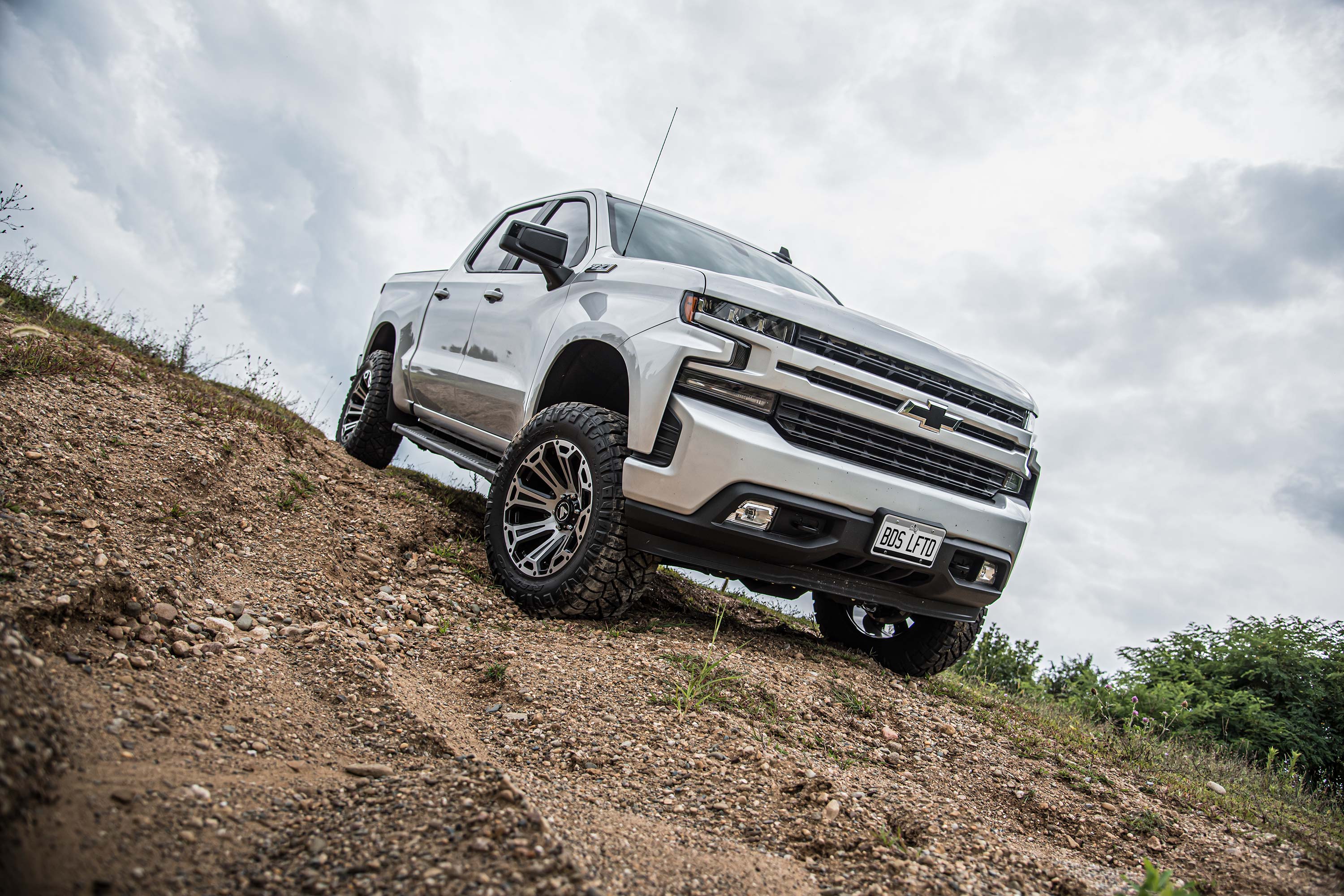 Chevy Trail Boss with a 2.5-inch lift kit and FOX 2.5 Performance Elite Coil-Over on rugged terrain.