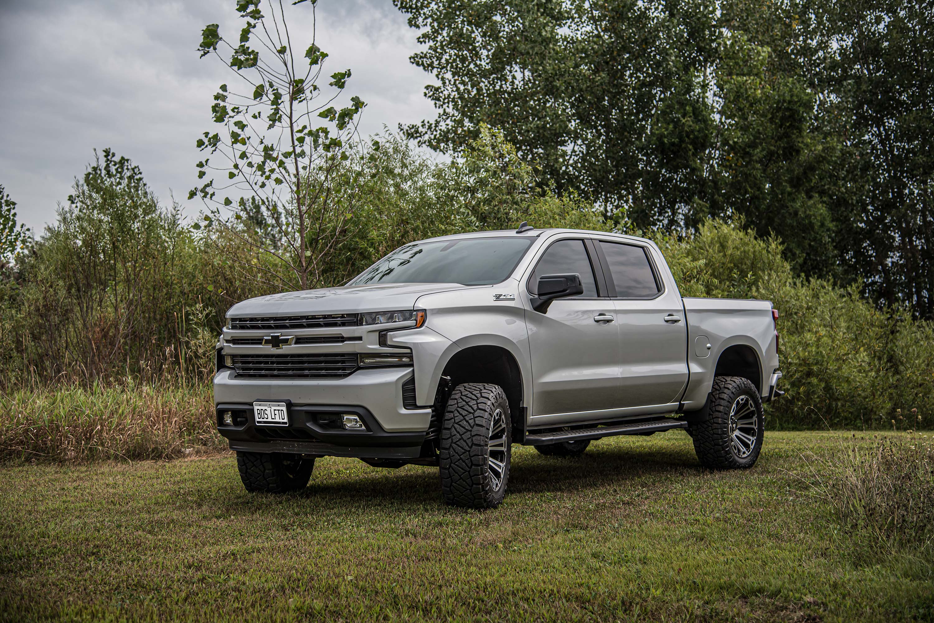4-inch lift kit with FOX 2.5 Performance Elite Coil-Over installed on a lifted Chevy Silverado 1500 in a natural setting.