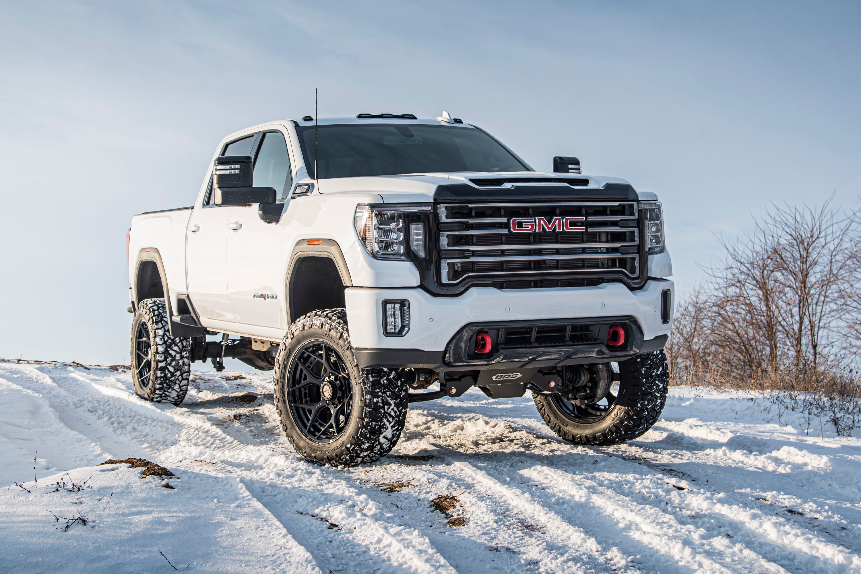 6.5 inch lift kit for Chevy Silverado or GMC Sierra 2500HD/3500HD, showcasing a lifted truck in snowy terrain.