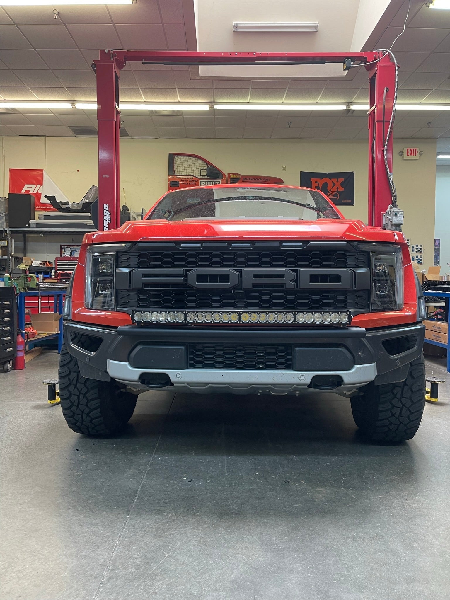 2024 Raptor Front Light Mount Kit displayed on a red truck, showcasing a modular bumper designed for versatile light installation.