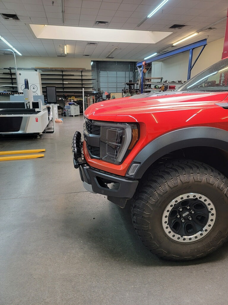 2024 Raptor Front Light Mount Kit on a red truck, showcasing a modular bumper designed for versatile light installation.