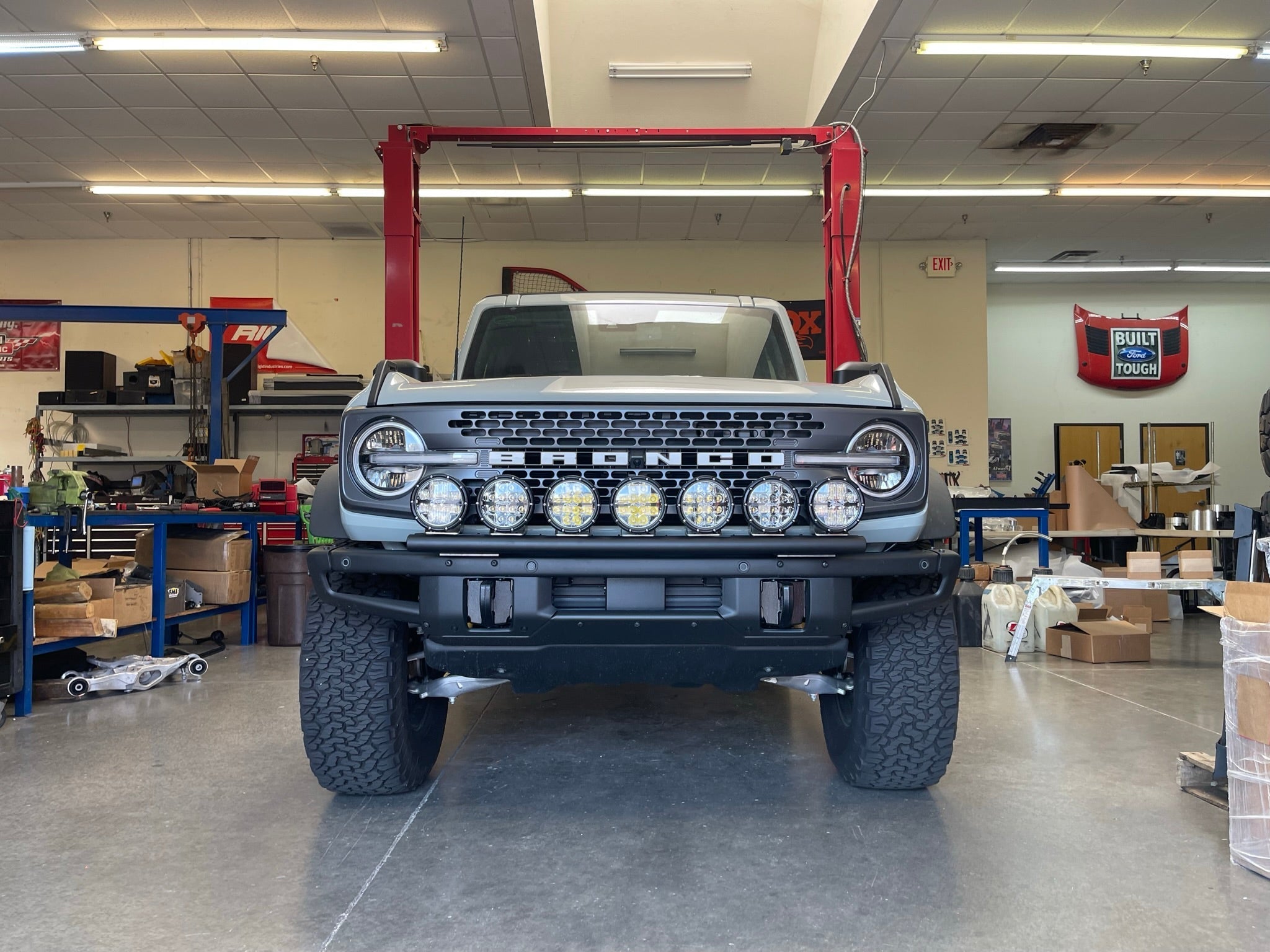 2022-UP Bronco Raptor front light mount kit displayed on a Bronco, showcasing multiple light options in a workshop setting.