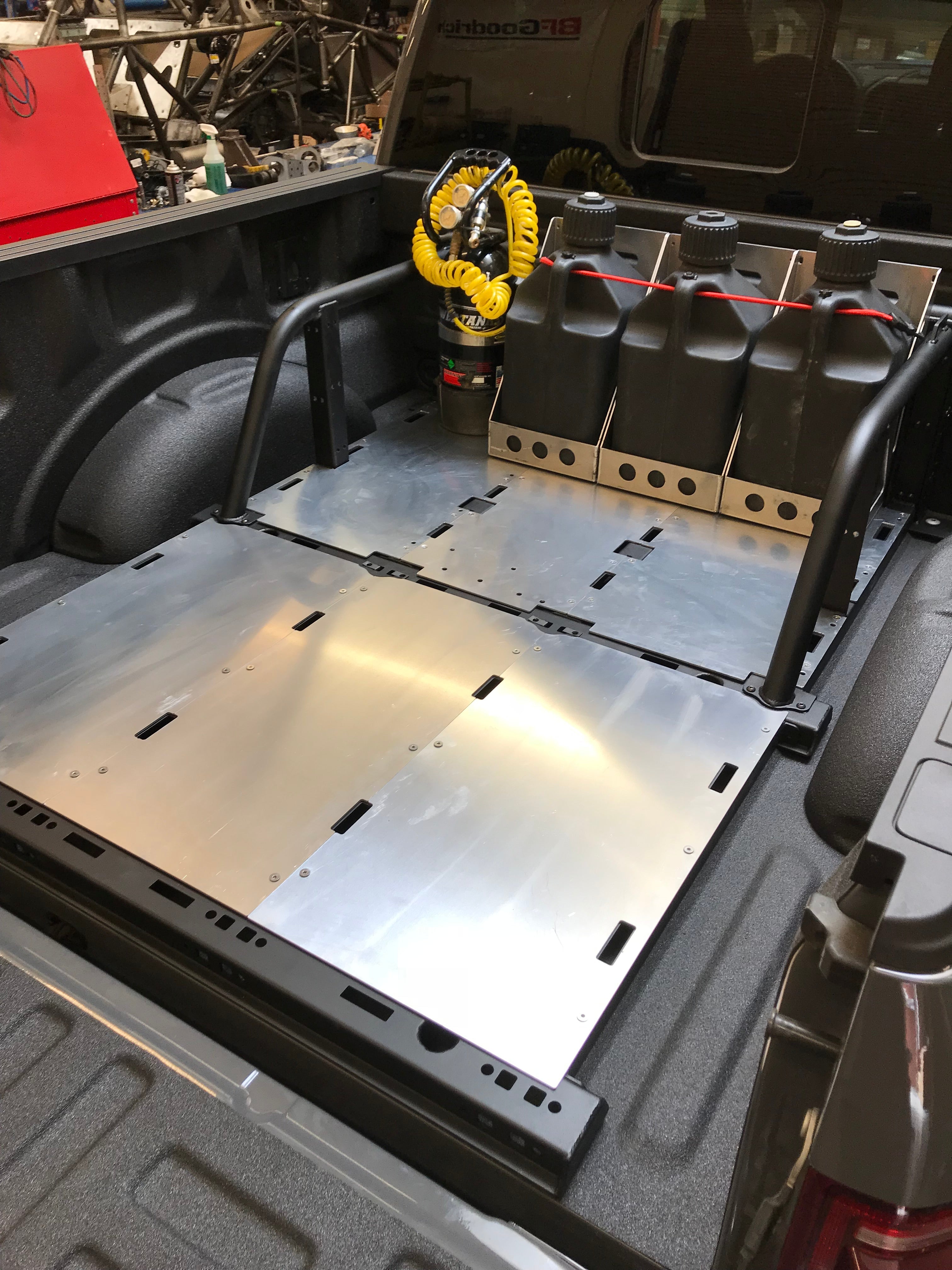 Modular bed organizer for 2017-2024 Ford Raptor and F150, featuring storage for tools and equipment in the truck bed.