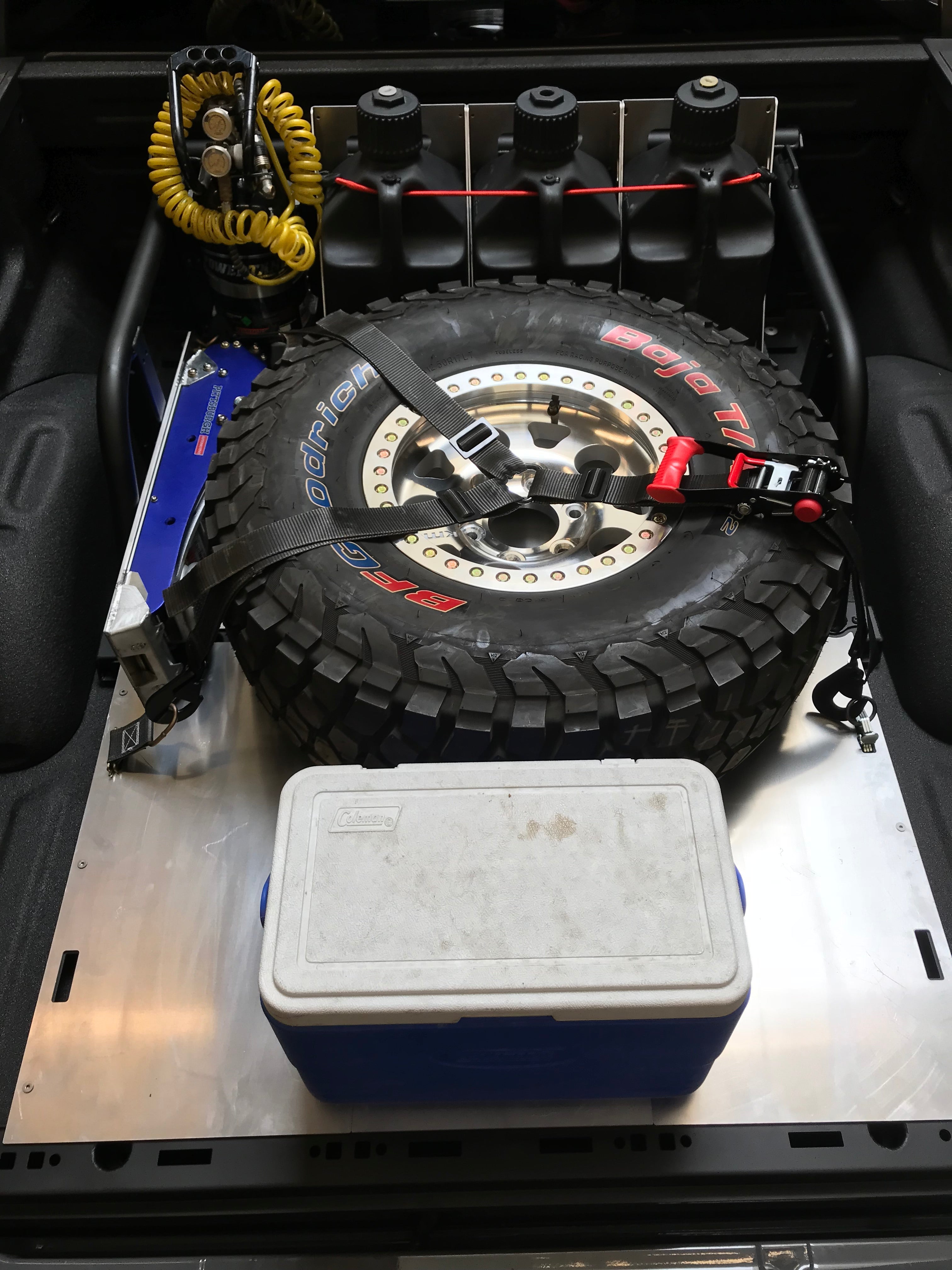20-inch rear travel bed organizer kit for 2017-2020 Raptor, featuring a mounted spare tire and storage cooler.