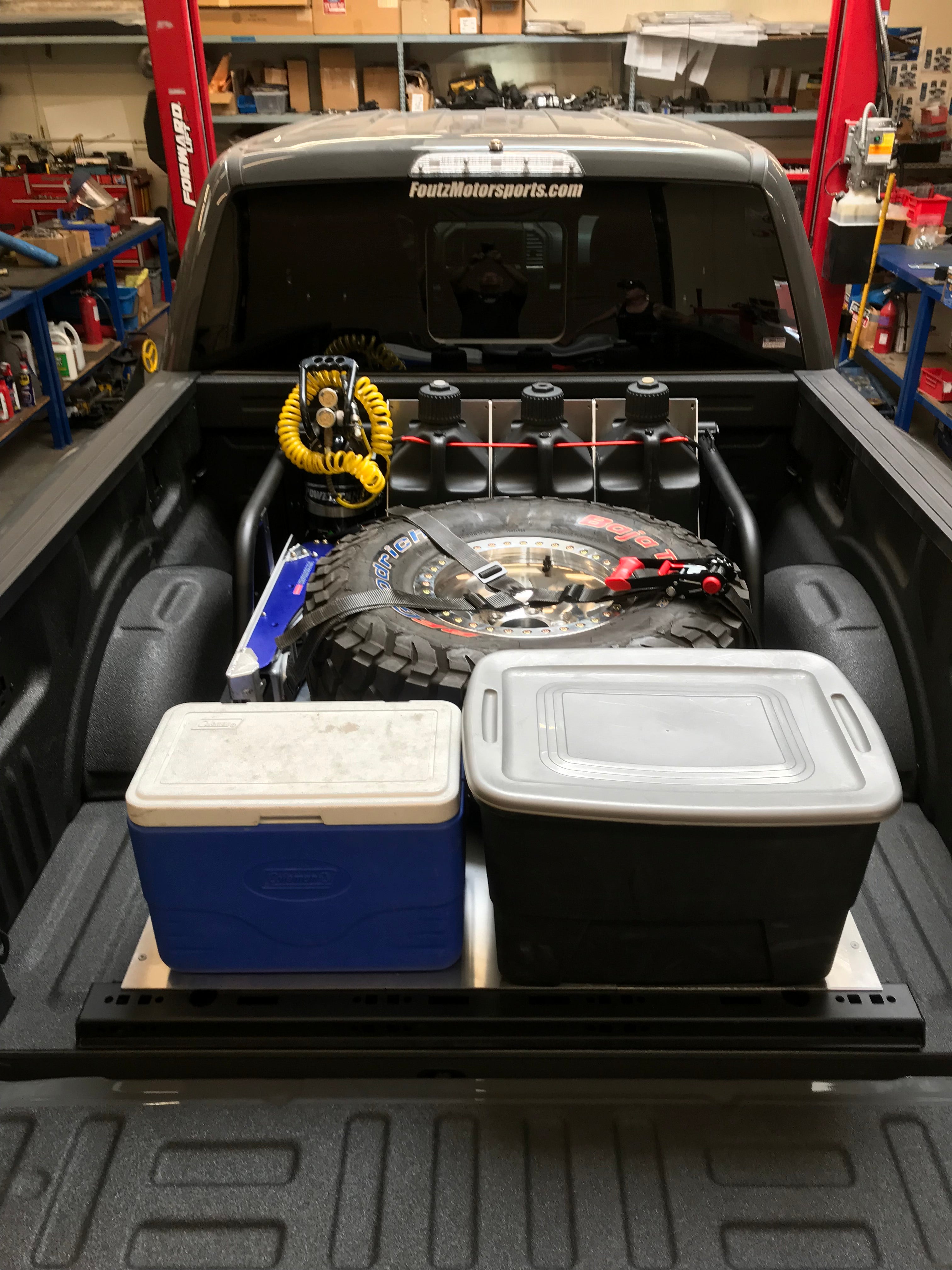 Modular bed organizer for 2017-2024 Ford Raptor and F150, showcasing tools and gear in a truck bed setup.
