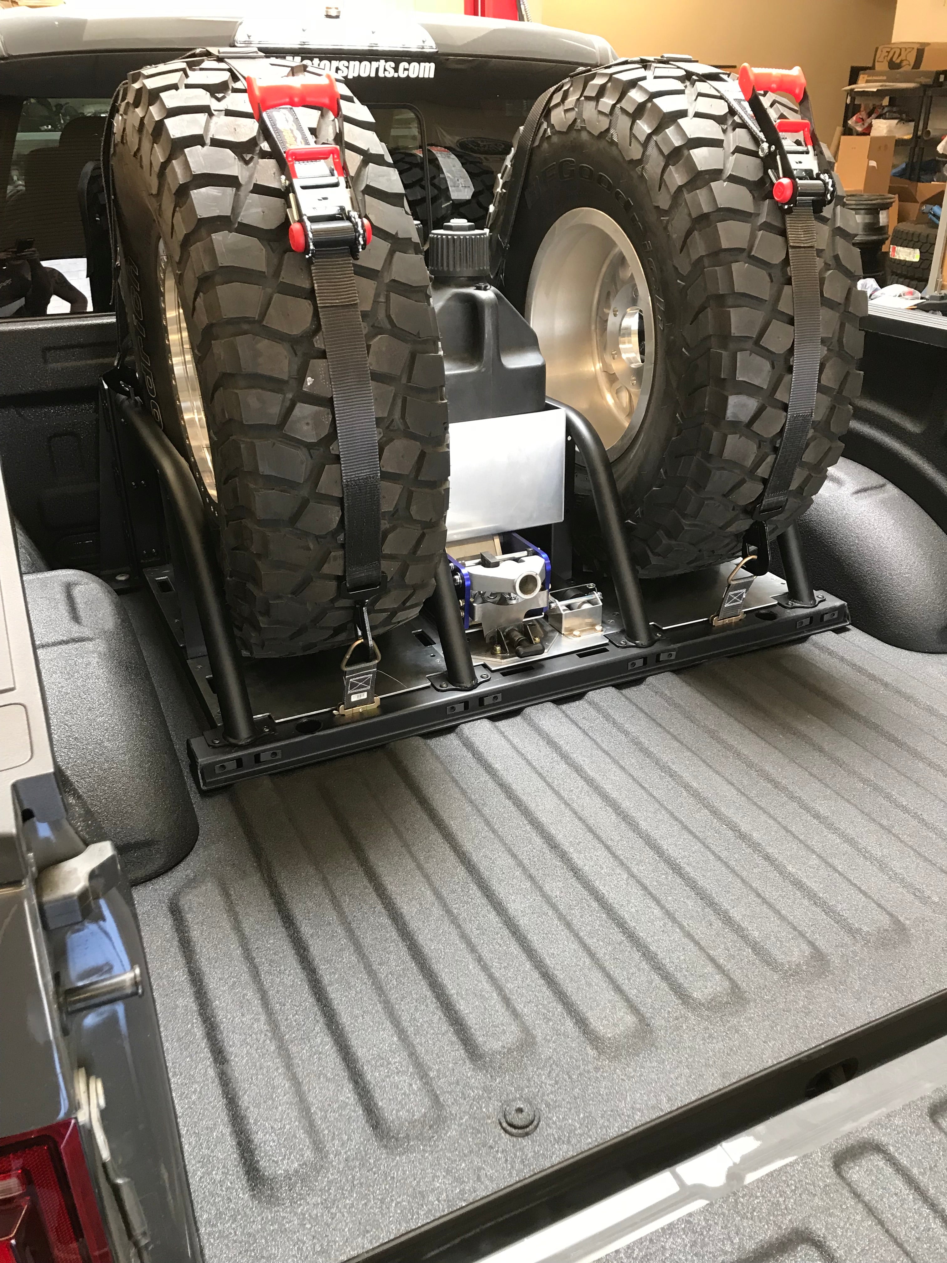 Modular bed organizer for 2017-2024 Ford Raptor featuring a slide-out cargo tray and secured spare tires.