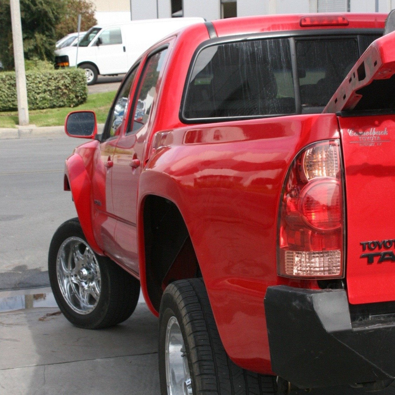 2005-2015 Toyota Tacoma bedsides showcasing a red truck with a modified rear end, emphasizing offroad capabilities.