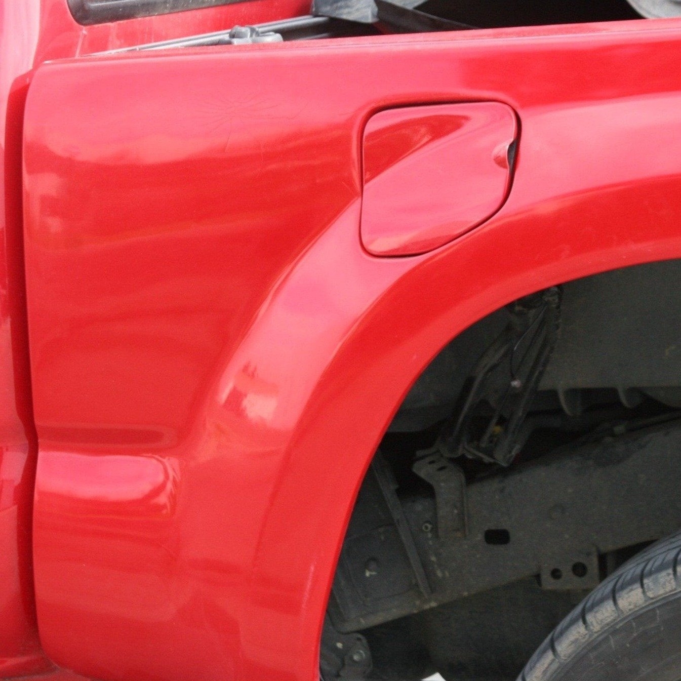 Red Toyota Tacoma bedside panel for 2005-2015 models, showcasing a smooth finish and precise fit for truck customization.