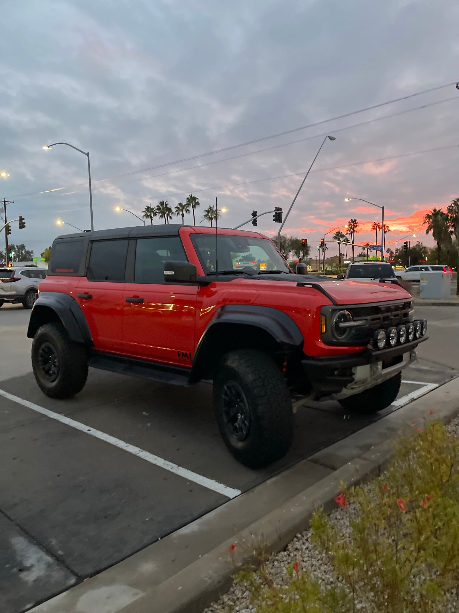 2022-UP Bronco Raptor with a front light mount kit, showcasing versatility for various light options in an urban setting.