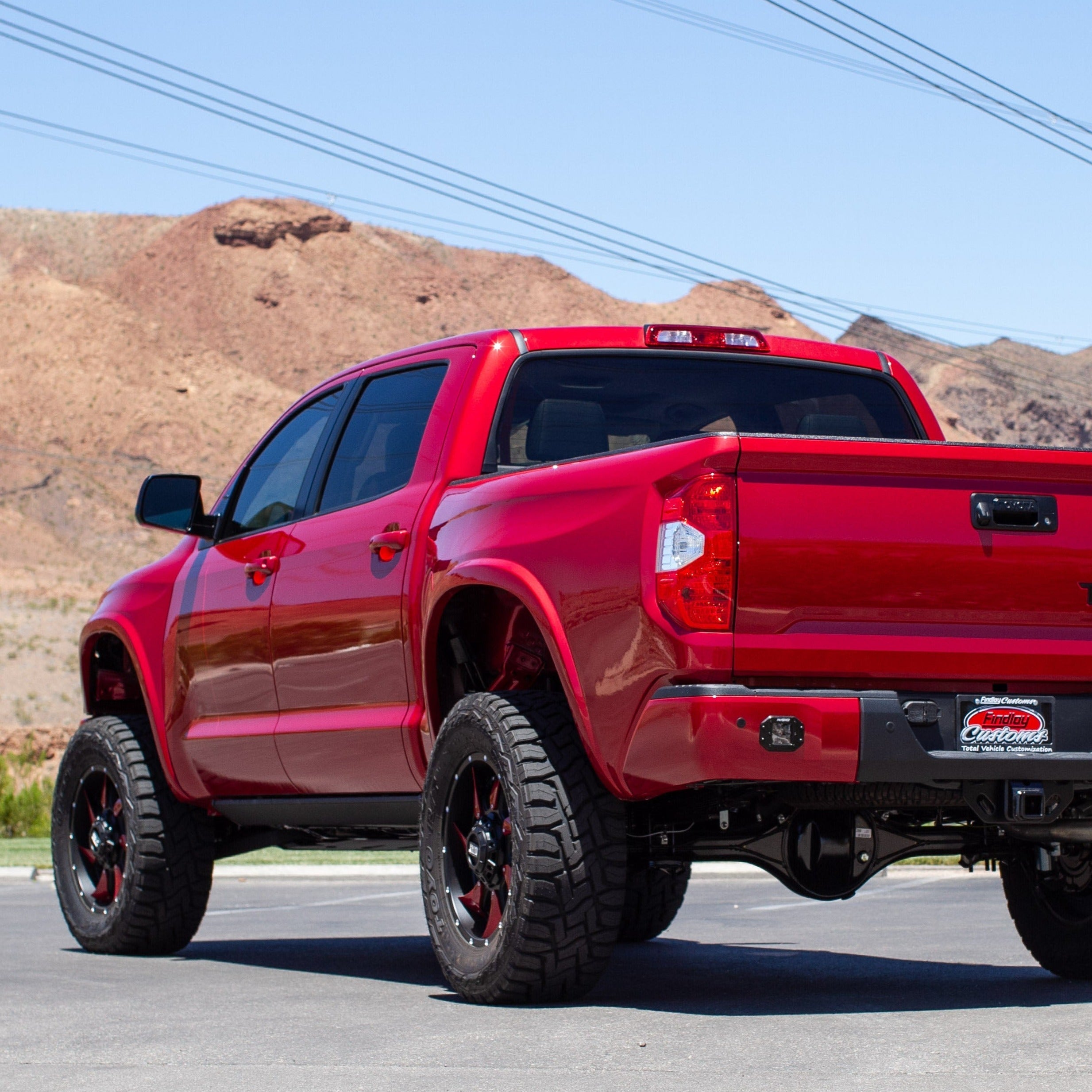 2014-2021 Toyota Tundra bedsides showcased on a lifted red truck against a desert backdrop, highlighting offroad capabilities.