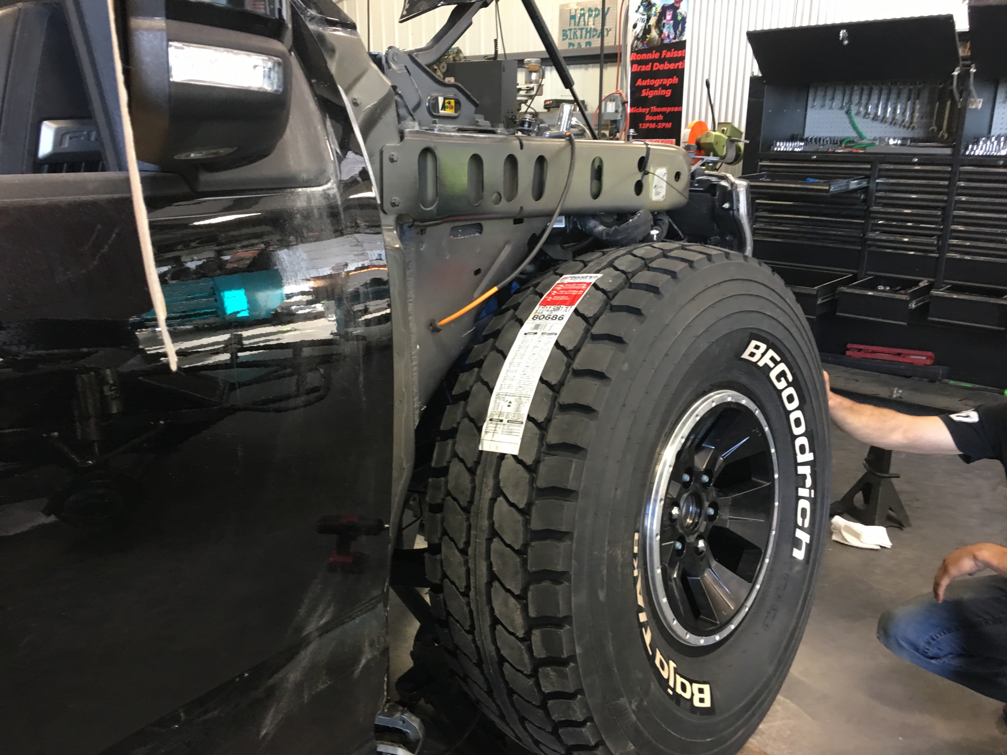 2017 Up Raptor Long Travel Front Suspension Kit installed on a truck, showcasing enhanced suspension components and tire.