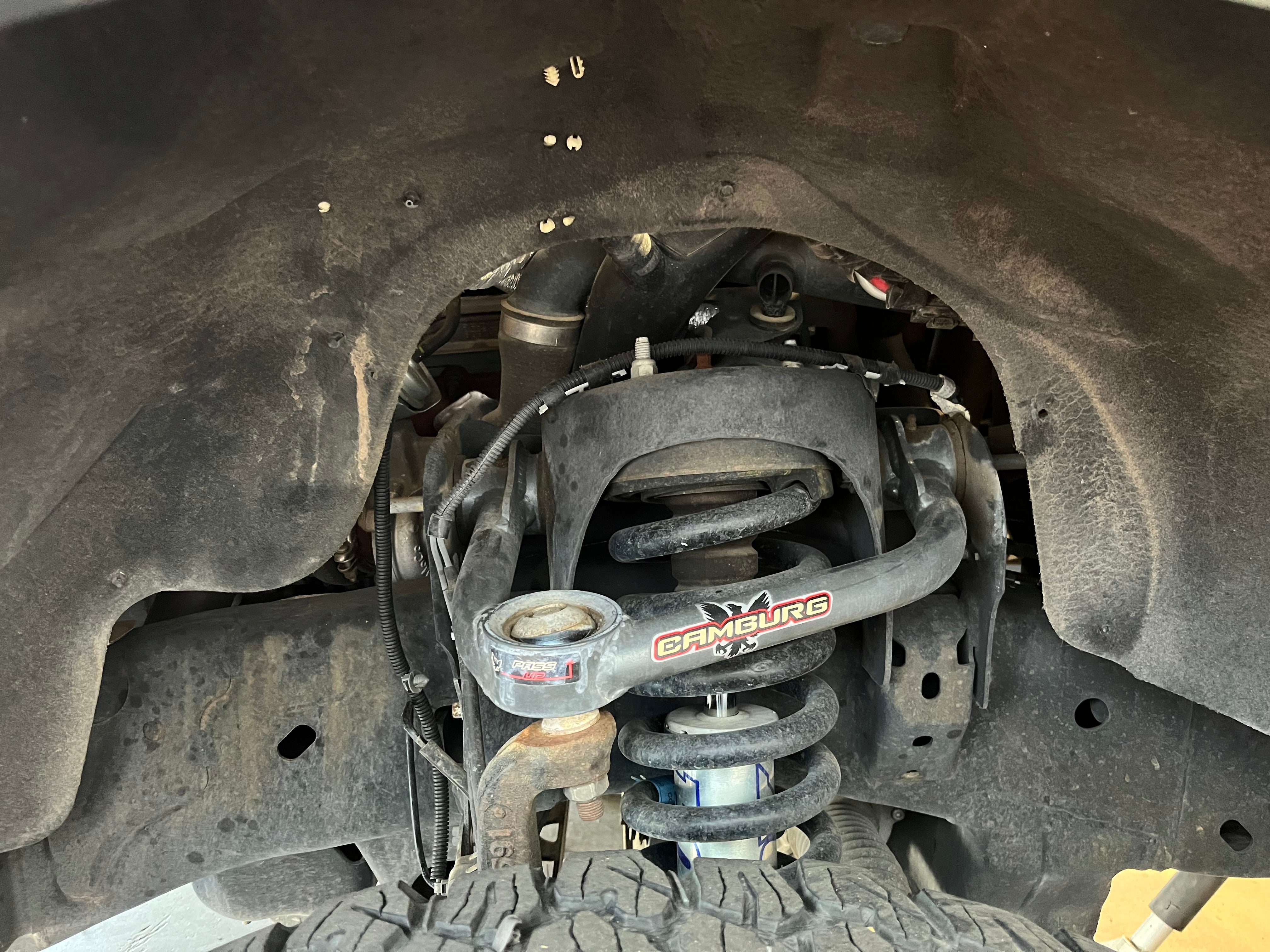 2010-2014 Ford F150 EcoBoost splash guards showcasing undercarriage protection and suspension components.