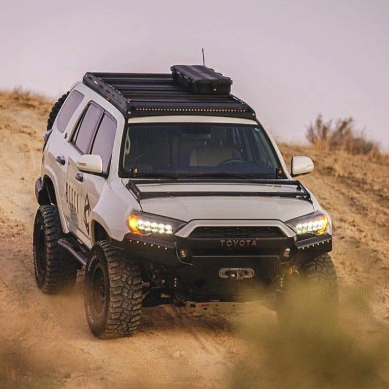 Toyota 4-Runner with aftermarket fenders, showcasing offroad capabilities on rugged terrain. Ideal for adventure enthusiasts.