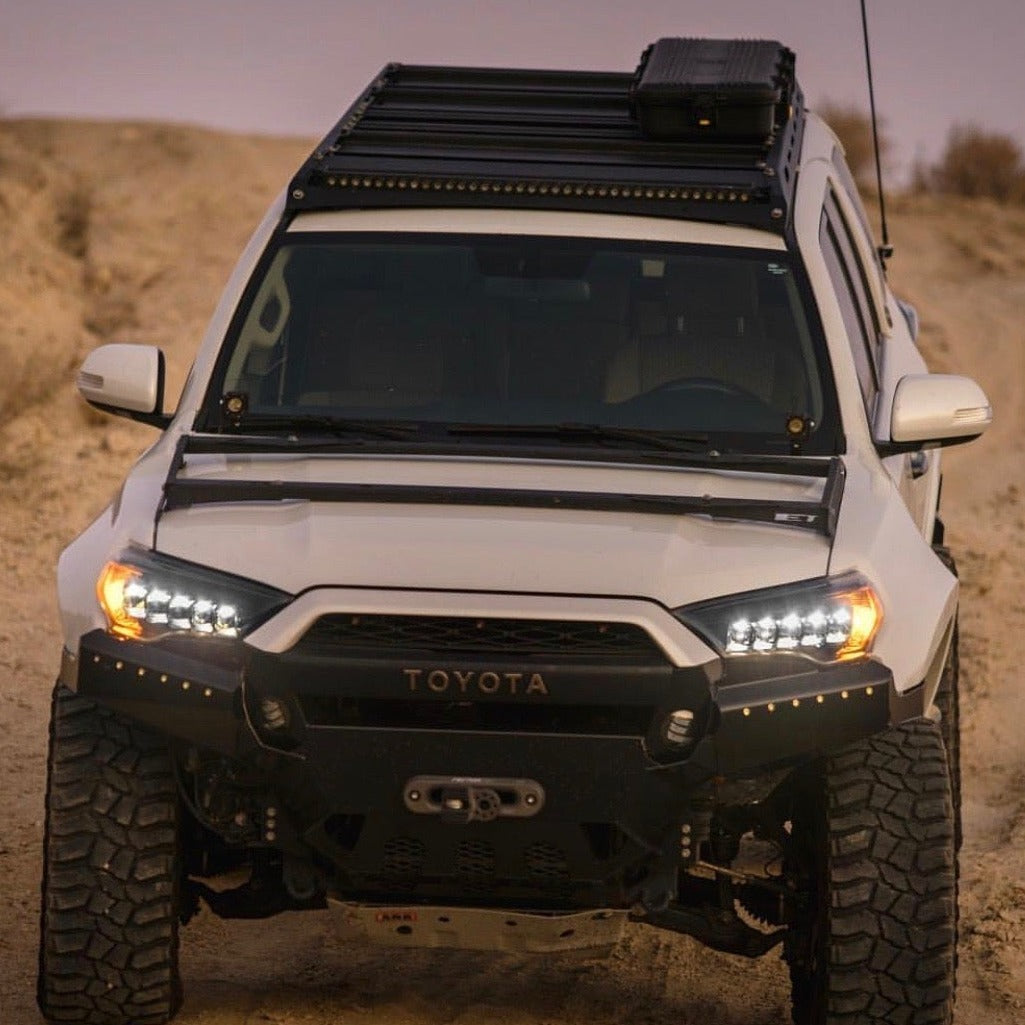 Toyota 4-Runner with upgraded fenders, showcasing rugged design and off-road capability in a desert landscape.