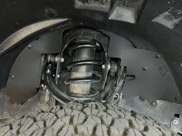 2017-2020 Ford Raptor splash guards installed, showcasing protection around the suspension and tire area.