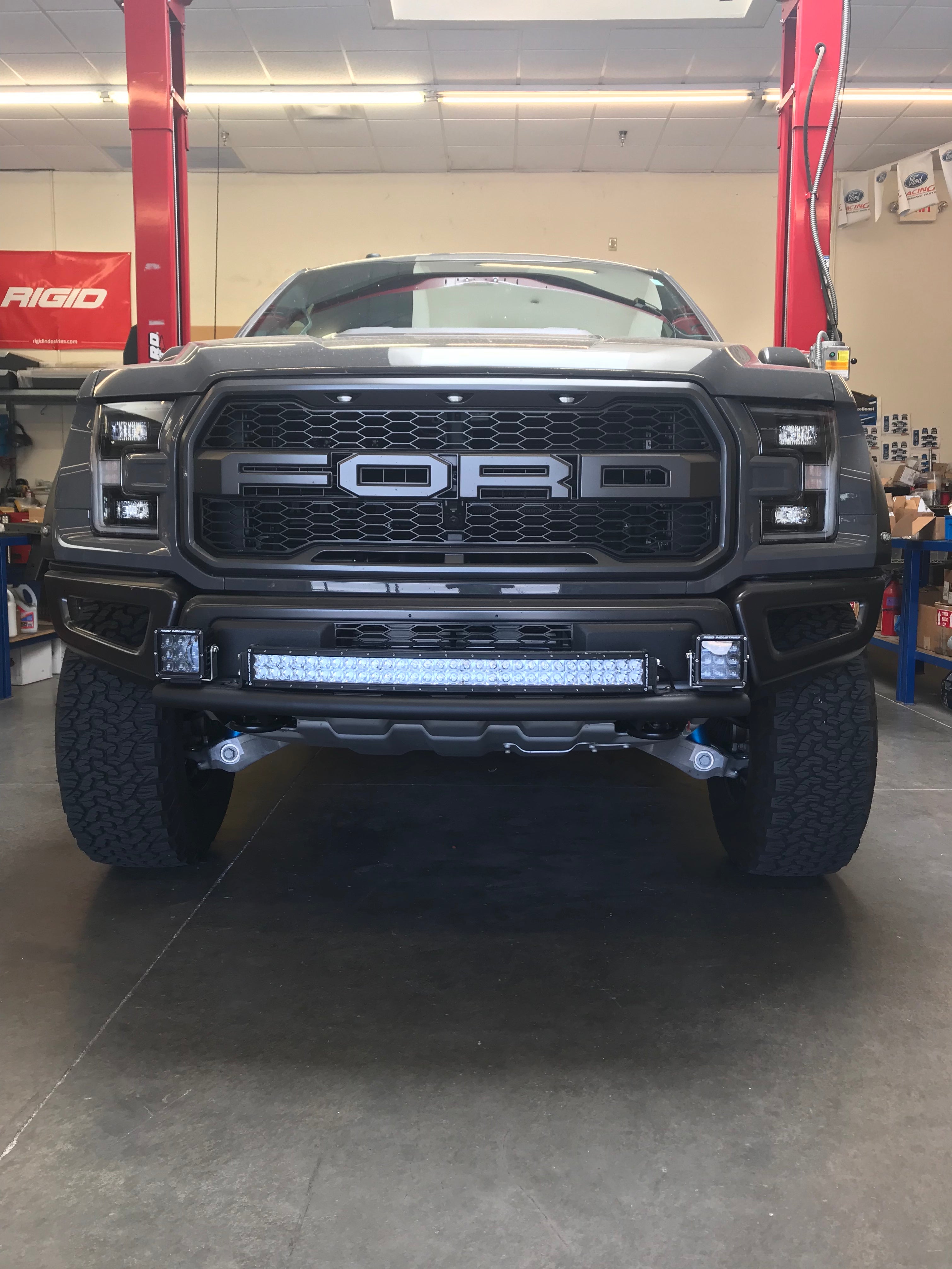 Single tube light mount installed on a 2017+ Raptor with stock bumper, showcasing offroad lighting capabilities.