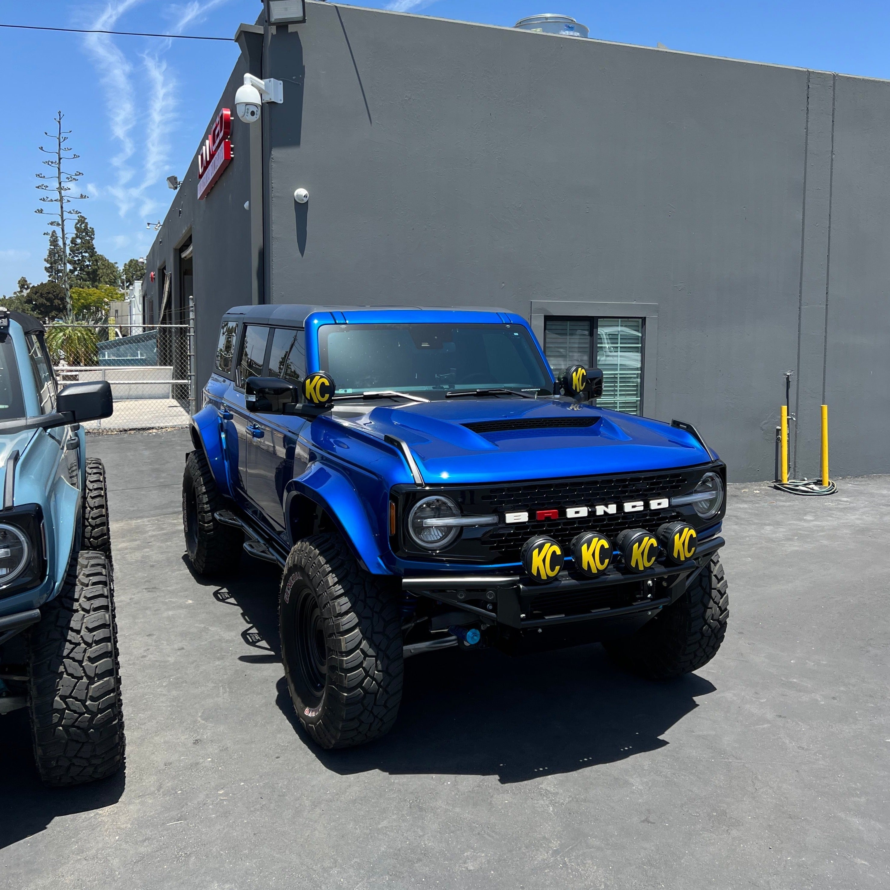 2021-2025 Ford Bronco with a Ram Air Hood, showcasing a bold blue exterior and off-road enhancements.